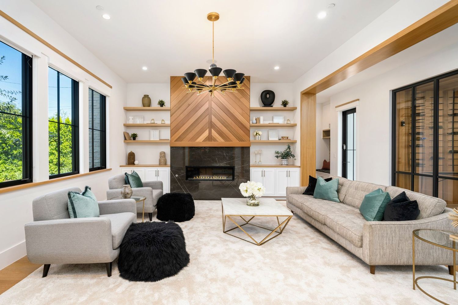 Contemporary living room with chevron fireplace wall and modern furnishings.