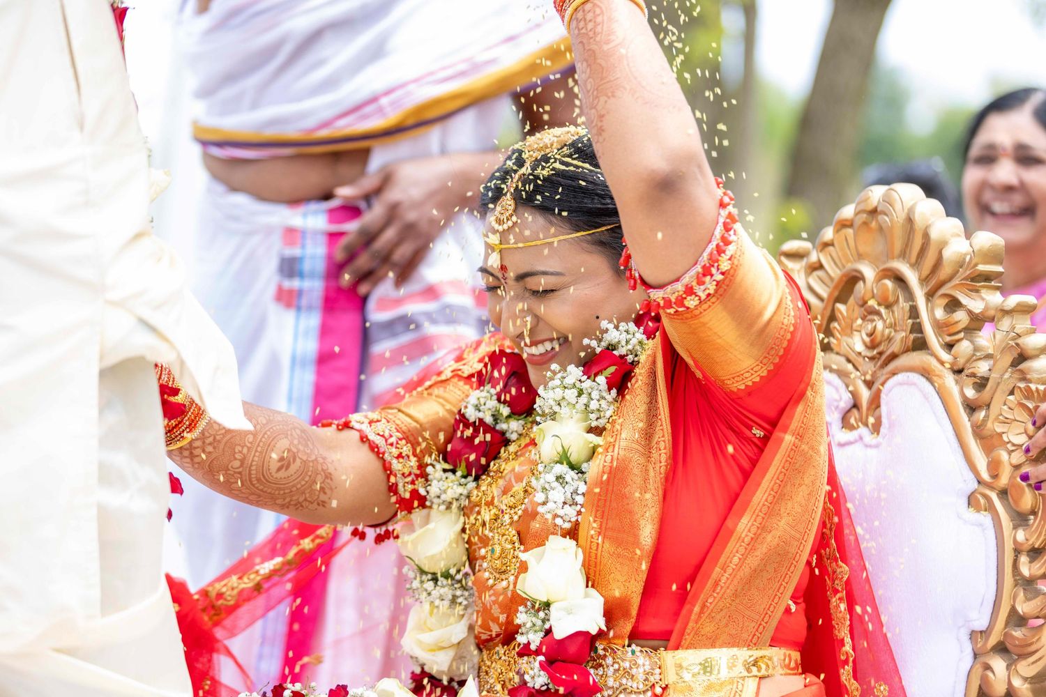 Joyful celebration during a traditional South Asian wedding ceremony with colorful decorations.