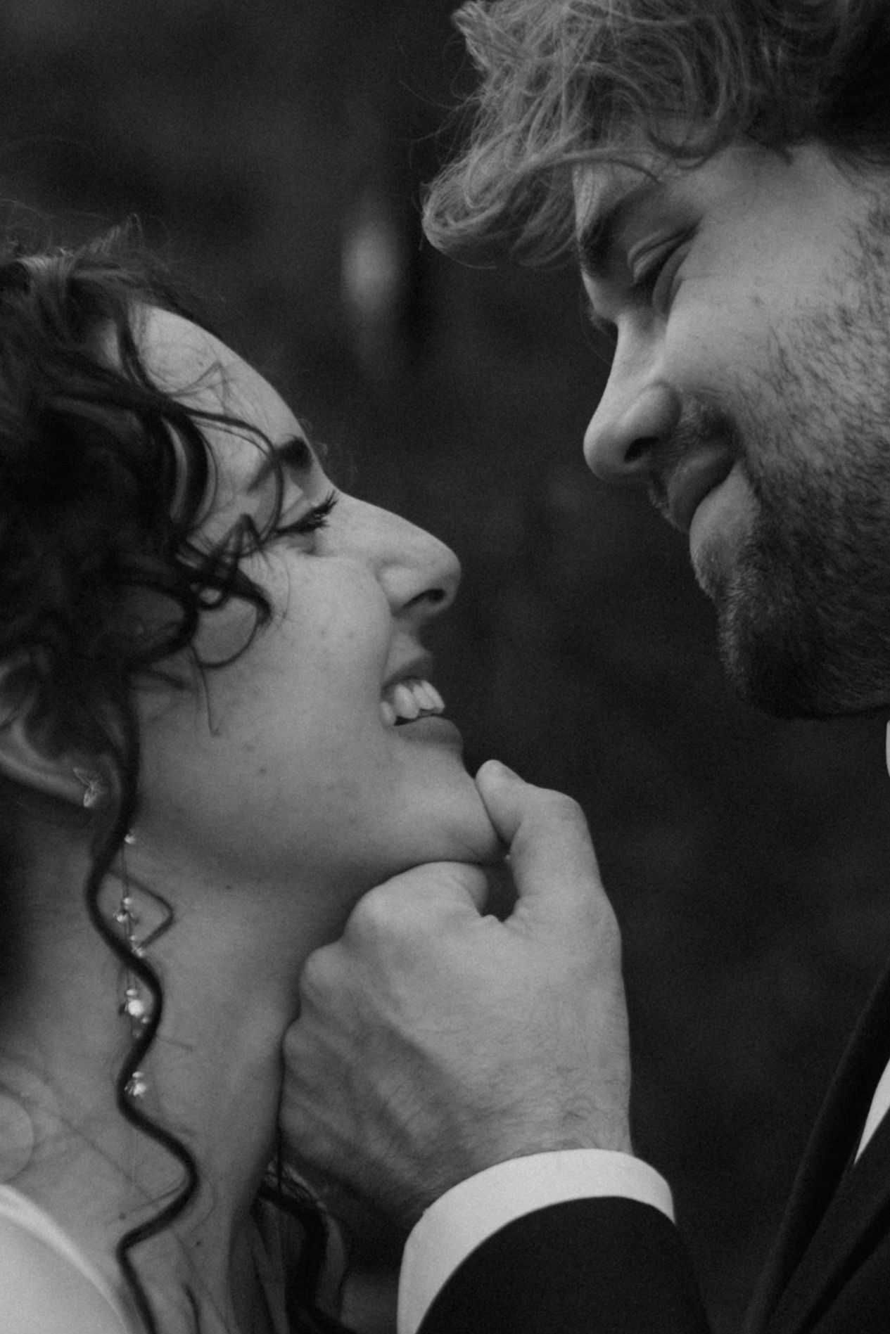 A tender black and white portrait capturing an intimate moment between newlyweds.