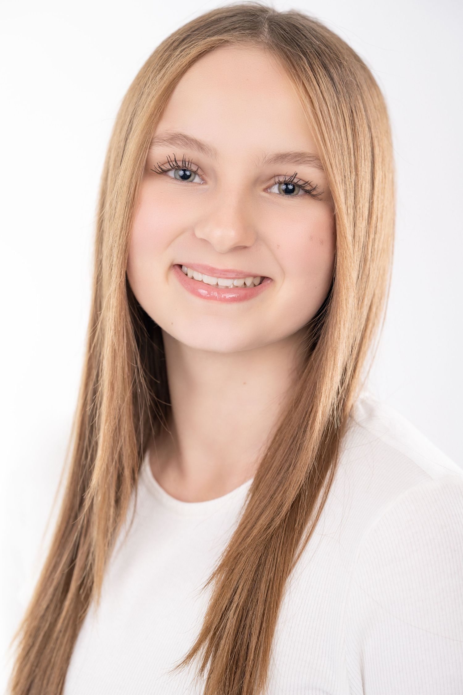 Professional headshot photo showing bright smile and long straight blonde hair against white background.