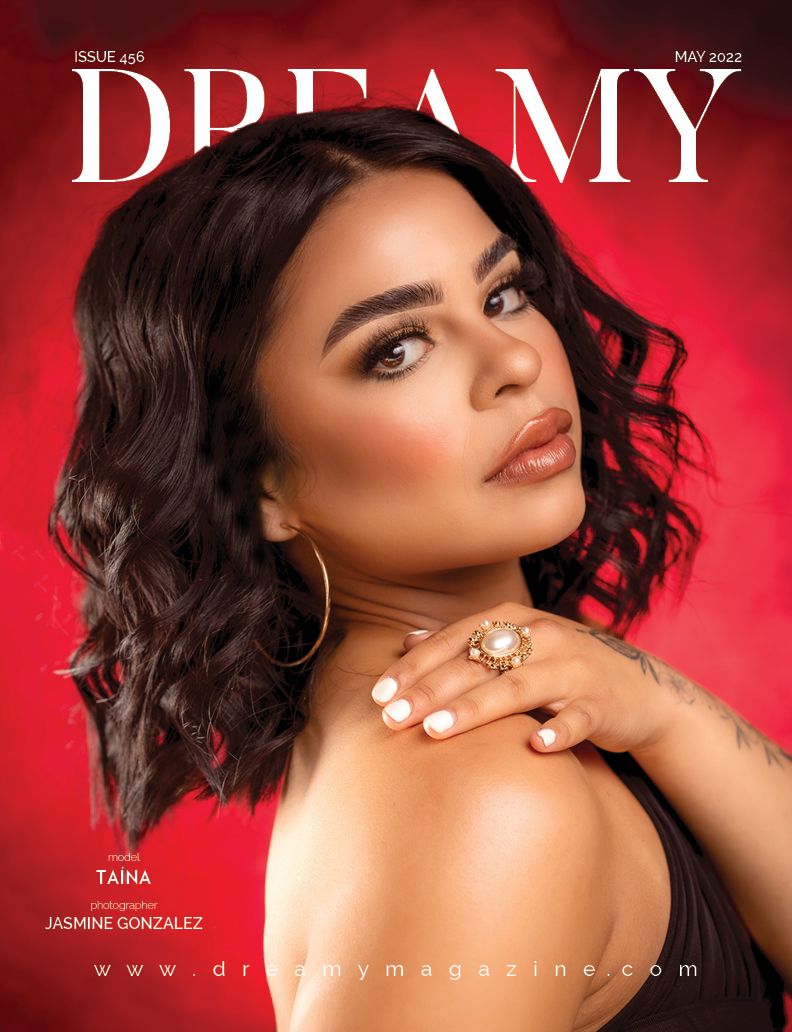 Fashion magazine cover with close-up beauty shot against vibrant red background showcasing glamorous makeup and jewelry.