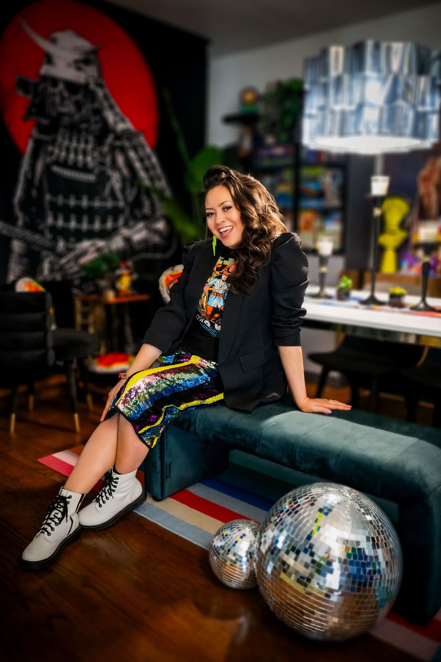 Disco balls rest on floor beside colorful decor and samurai wall art in retro-styled room.