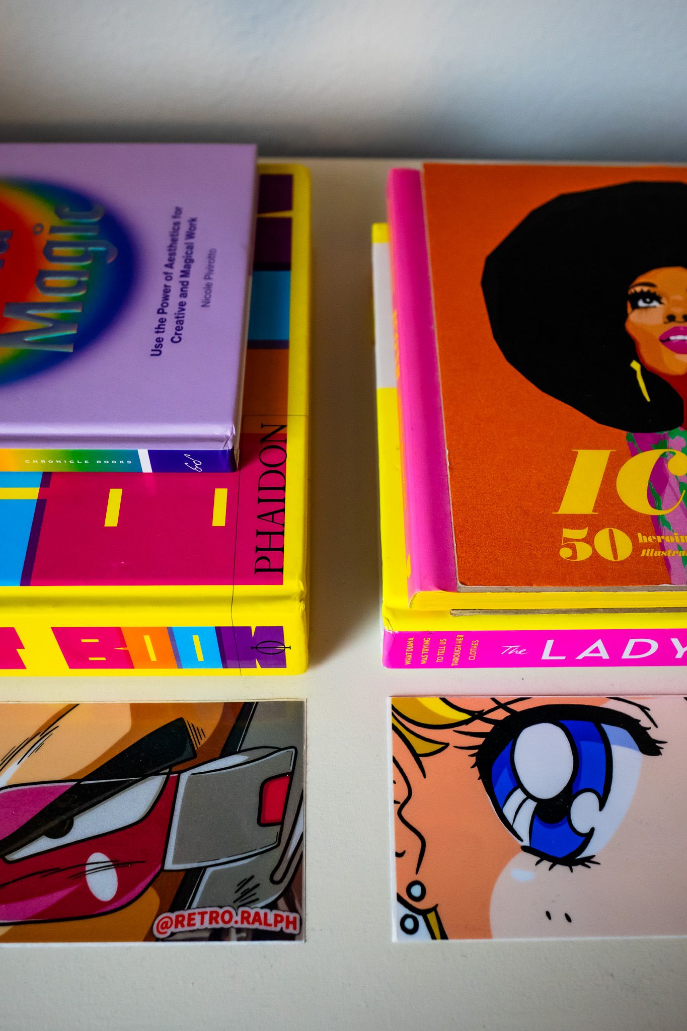 Collection of colorful retro-style books and manga featuring vibrant artwork and bold graphic designs on their covers.