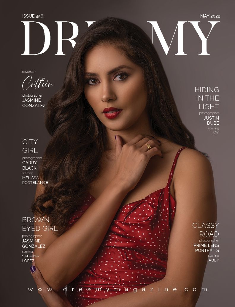 Fashion magazine cover featuring a model in a sparkling red dress with wavy hair posing elegantly against a dark background.