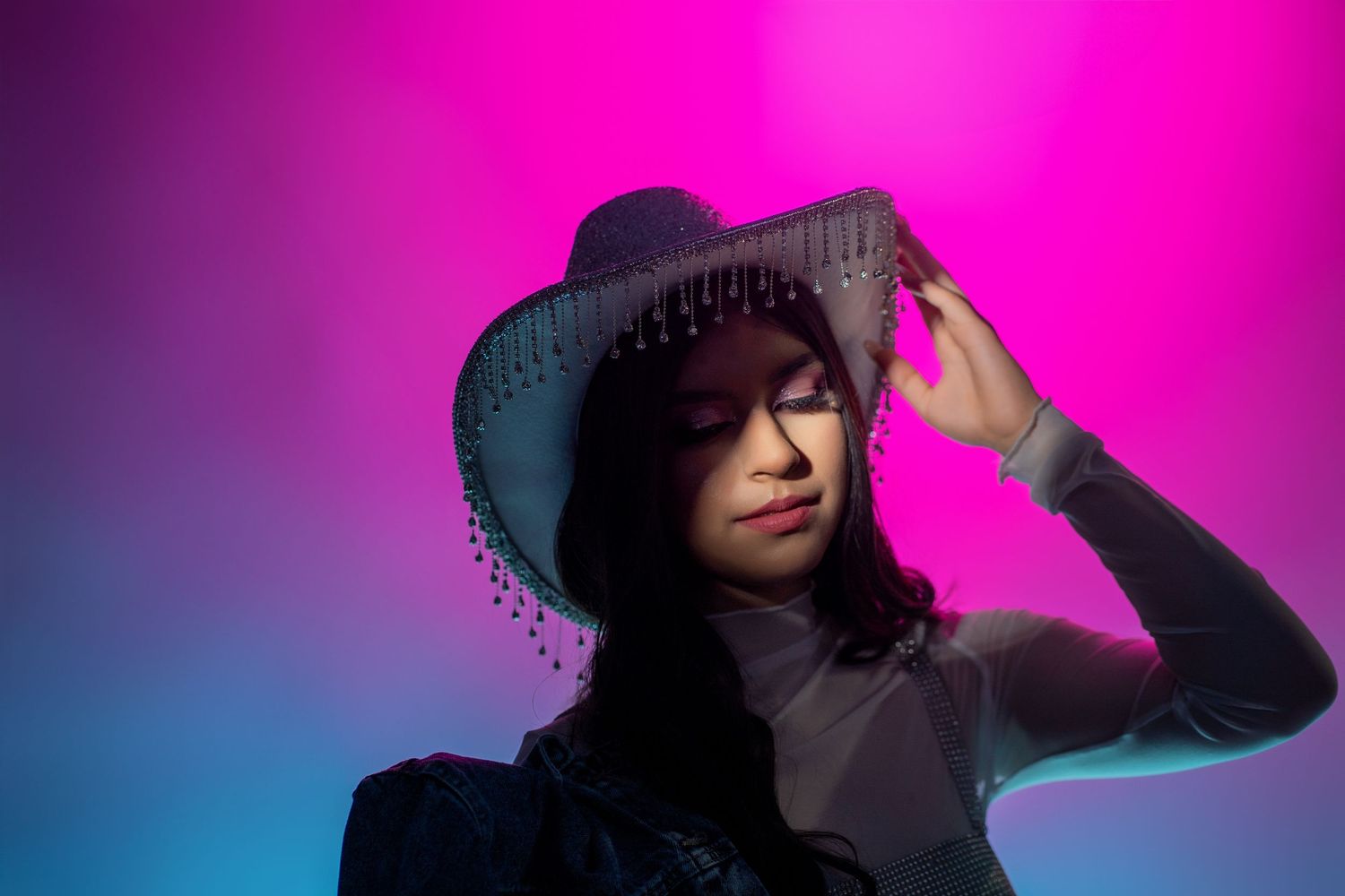 Studio Quinceañera Portrait with Colorful Neon Lighting and Cowgirl Hat Sacramento