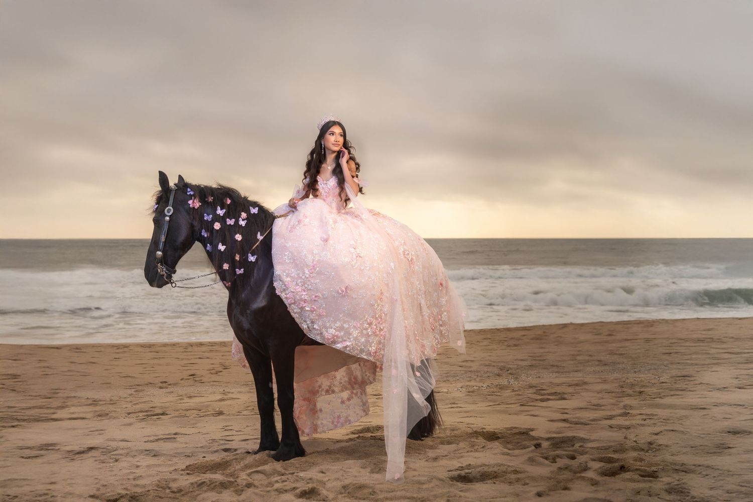 Quinceañera on black horse by ocean at Half Moon Bay California, destination beach quince photoshoot