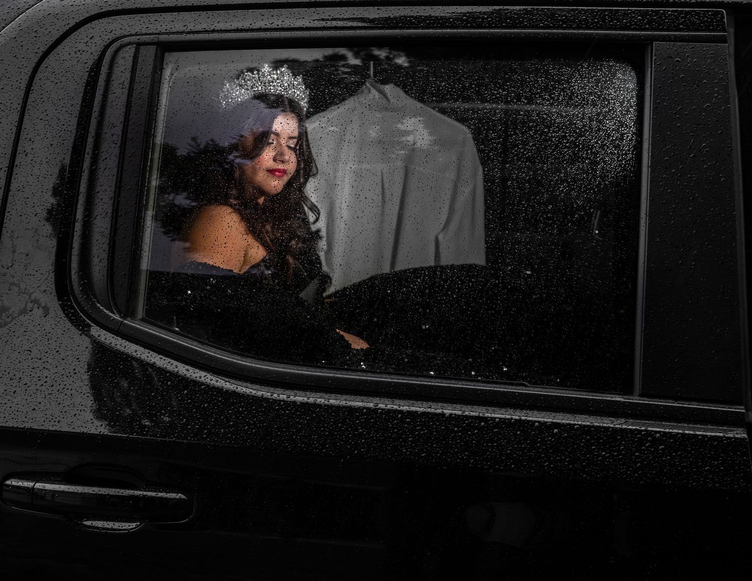 Candid quince portrait through rainy car window, crown detail, cinematic photography by The Padillas.