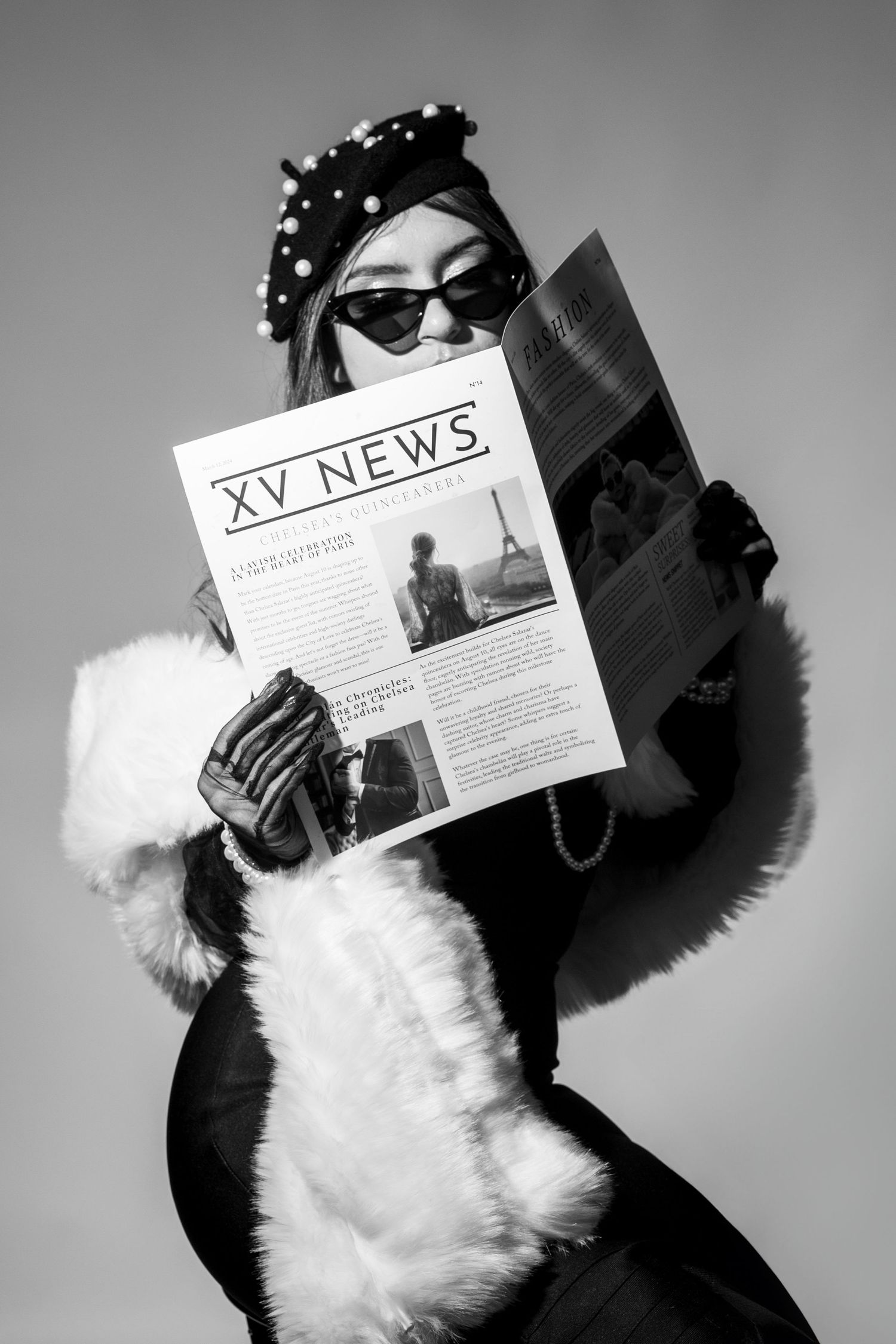 Quinceañera holding newspaper prop during black and white studio shoot in San Francisco fashion inspired