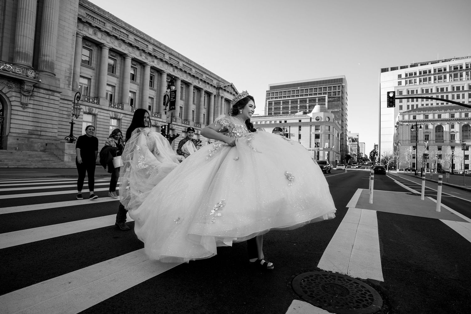 Quinceañera walking in gown across crosswalk in front of San Francisco City Hall | The Padillas