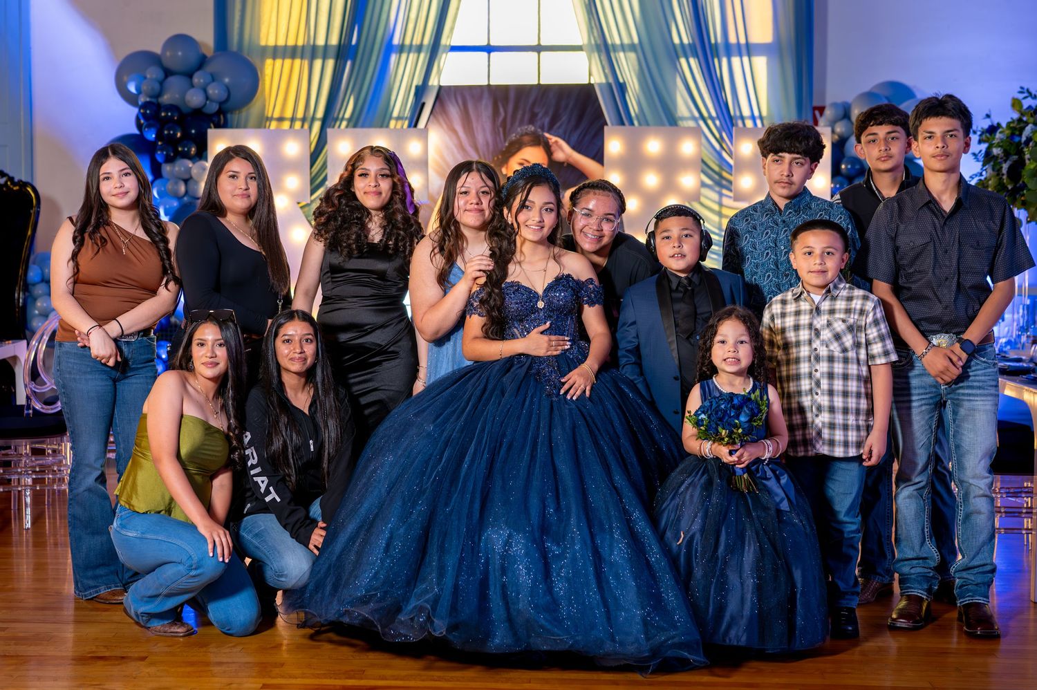 Quinceañera family portrait with navy blue dress at indoor event in Stockton
