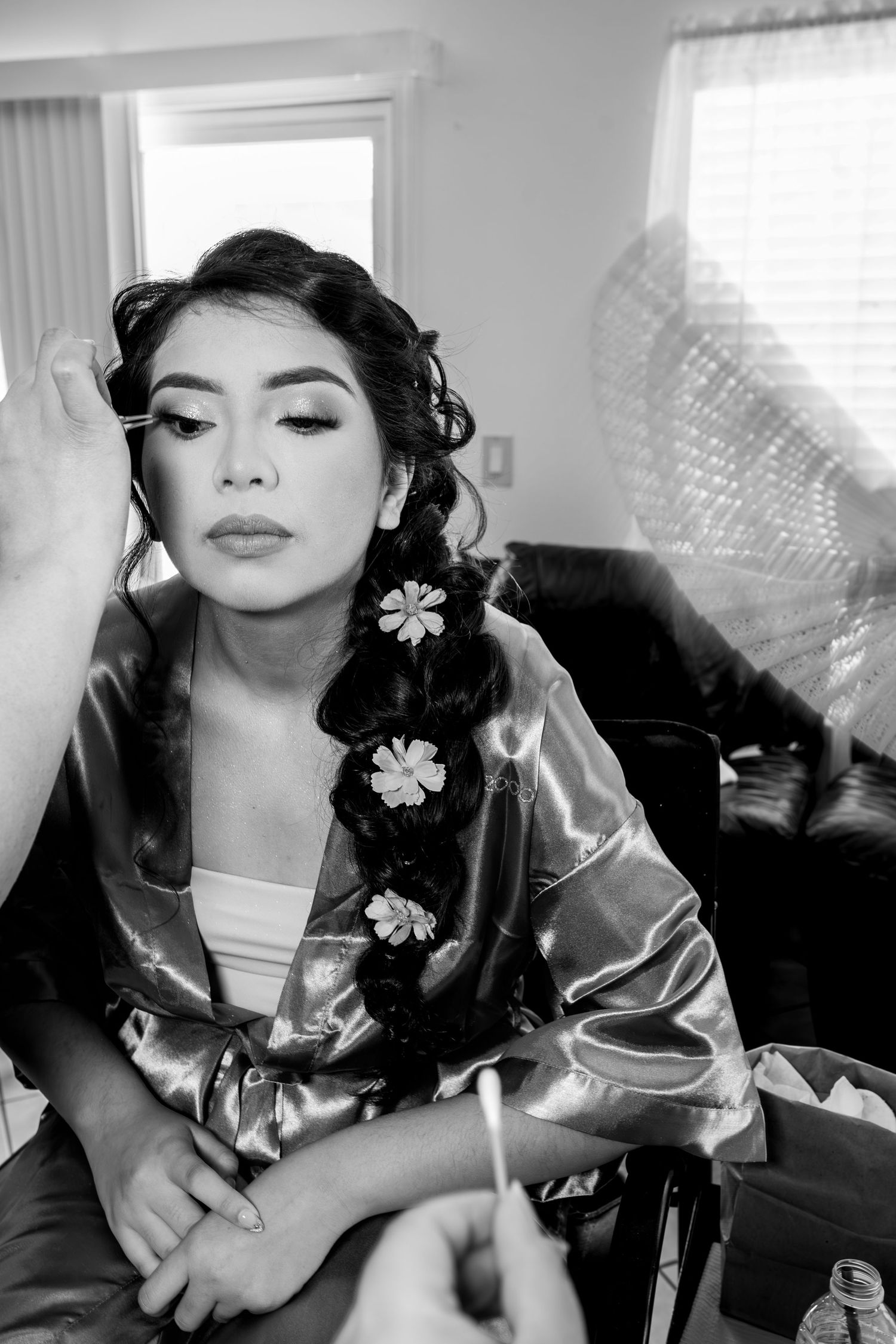 Quinceañera getting makeup done before event, candid getting ready photo by The Padillas, Sacramento quince photography.