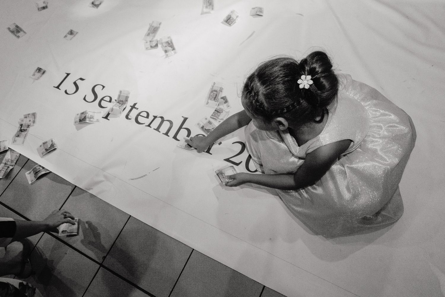 Overhead view of bridal gown with date 15 September written on floor.