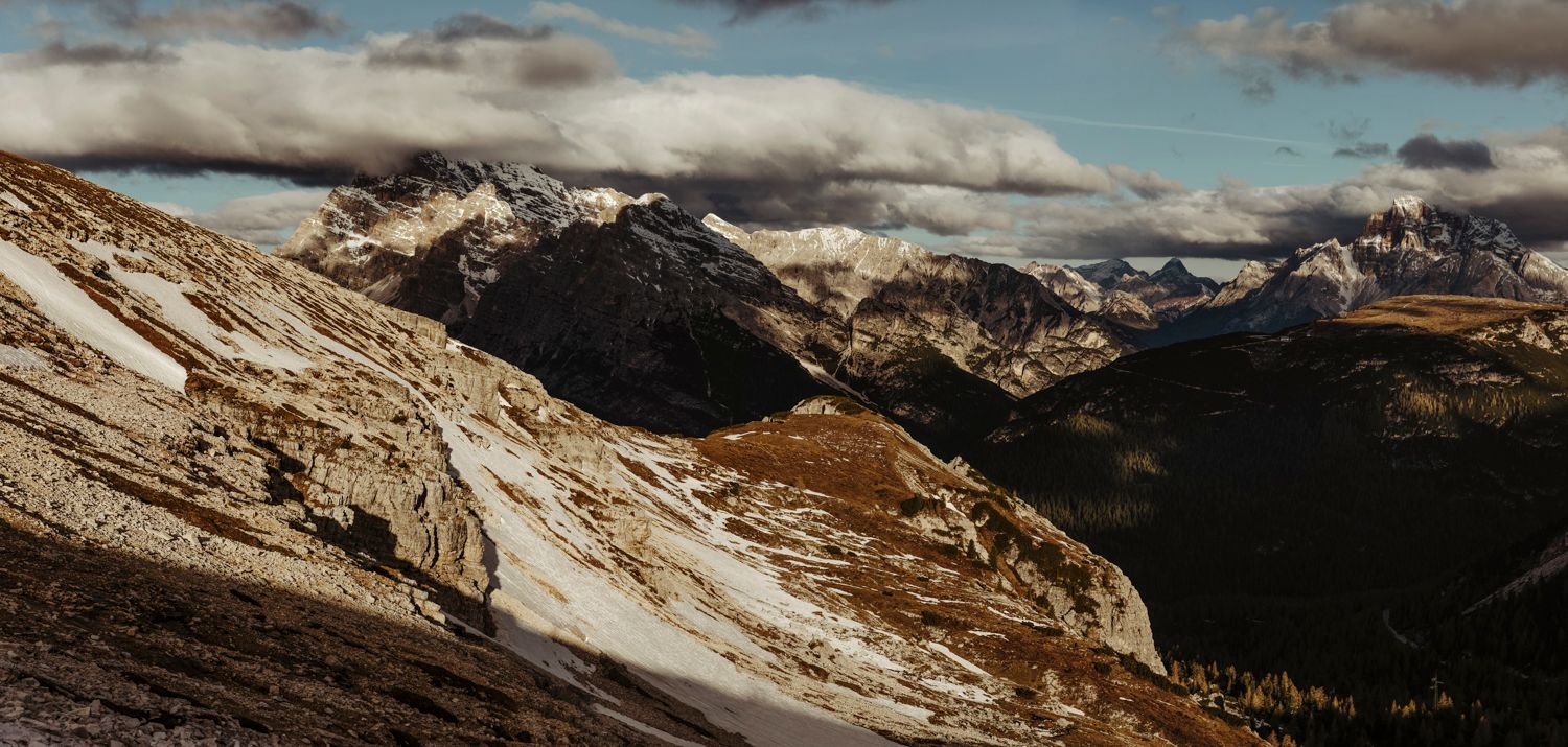 Stunning panoramic view of snow-capped mountain ranges and valleys in winter landscape.