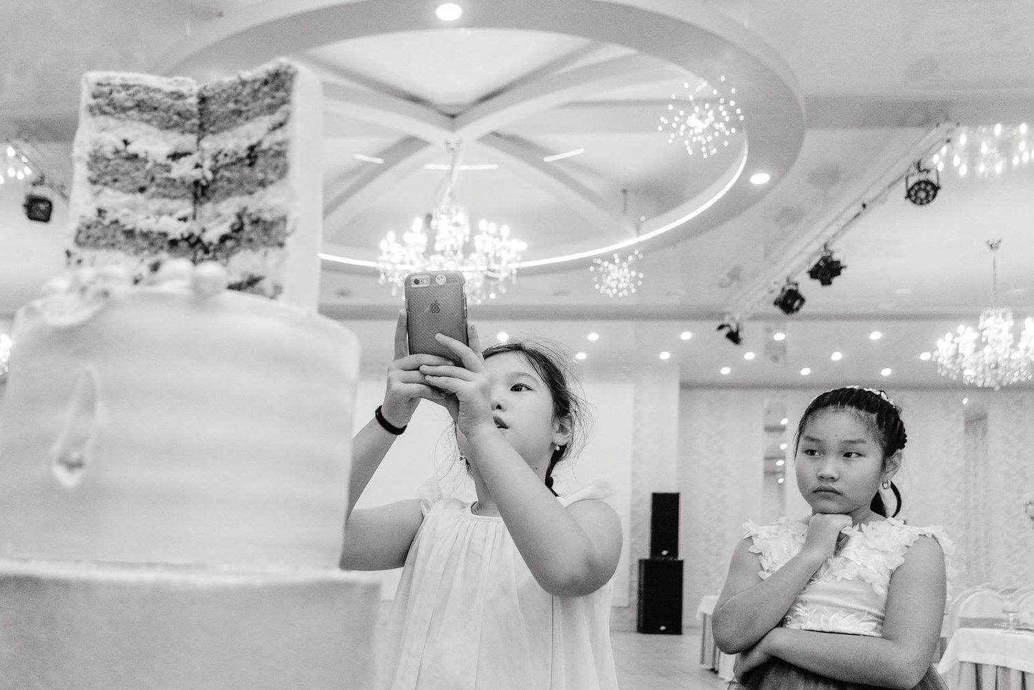 Two children blowing bubbles at an indoor celebration event.