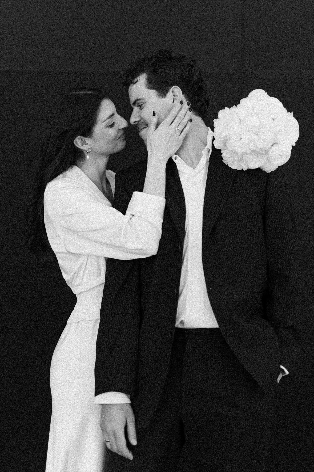 Artistic series of intimate wedding poses in black and white with dramatic lighting.