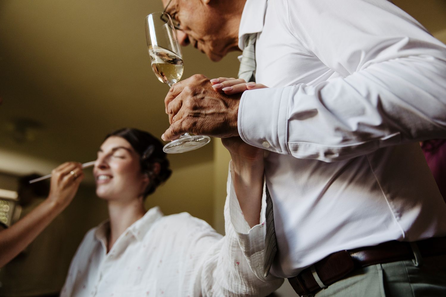 Wedding party enjoying drinks and toasting during celebration.