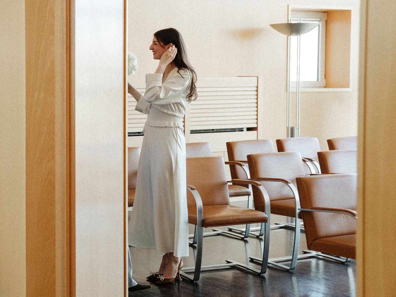 Empty hallway with beige walls and modern office furniture.