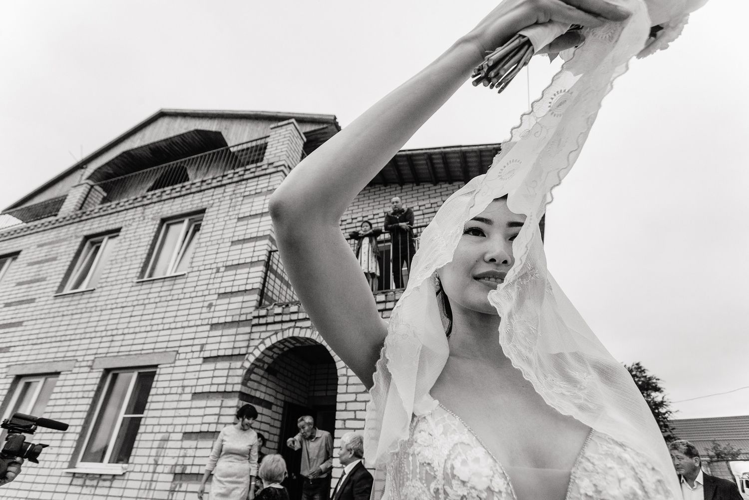 Artistic black and white wedding photographs capturing outdoor moments with dramatic angles.
