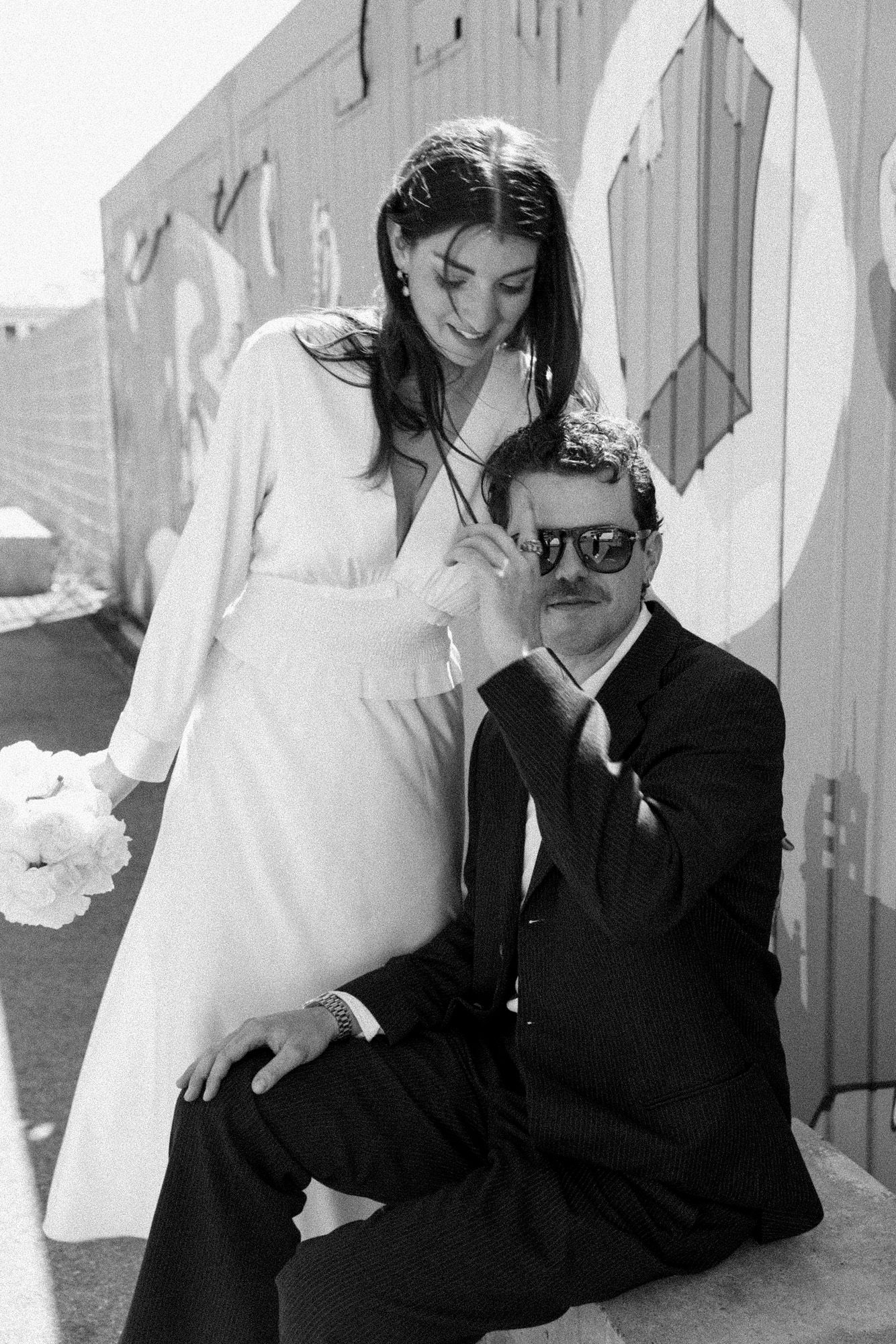 Artistic black and white wedding portraits with dramatic lighting and shadows.