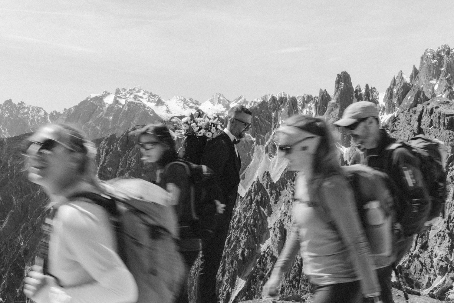 Motion blur photo of people celebrating in mountainous landscape.