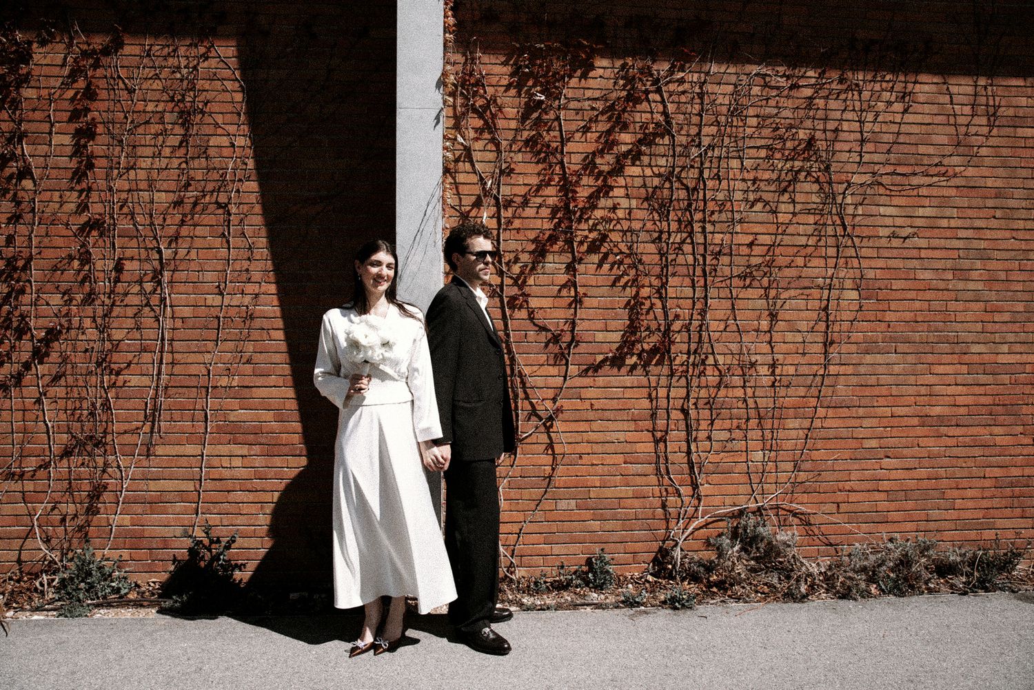 Wedding photography sequence against brick wall showing full length portraits.