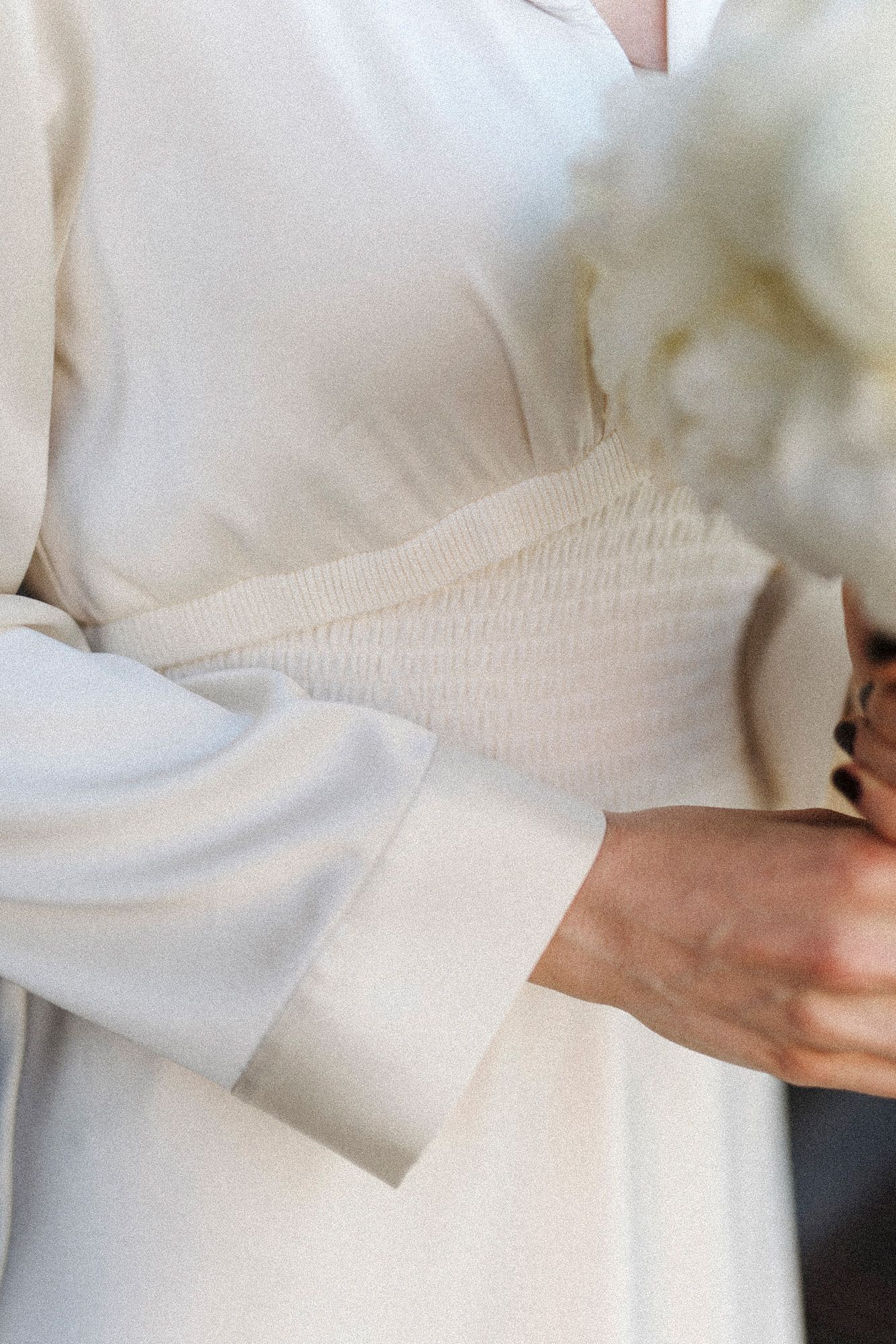 Detail shots of white wedding dress fabric and waistline.