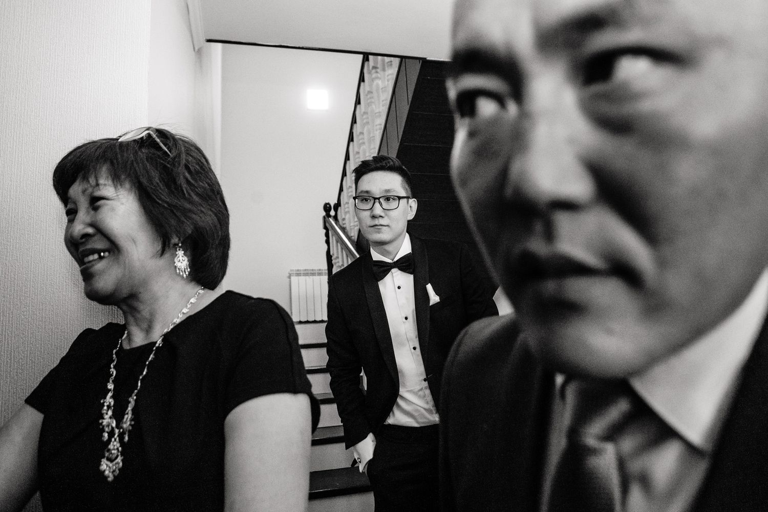 Intimate black and white candid photographs showing emotional moments during a wedding celebration.