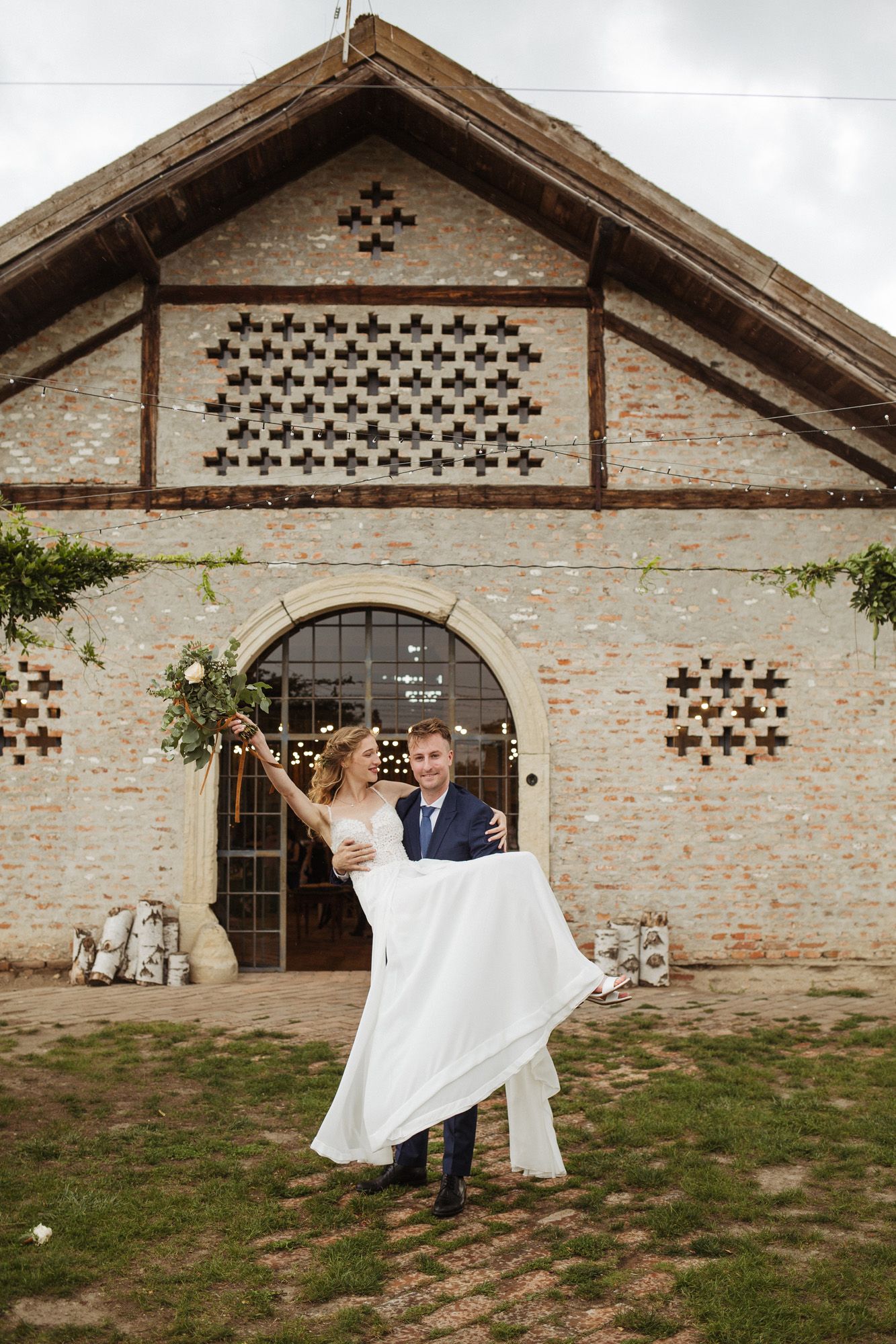 A celebration at a historic brick building with distinctive architectural details and arched doorway.