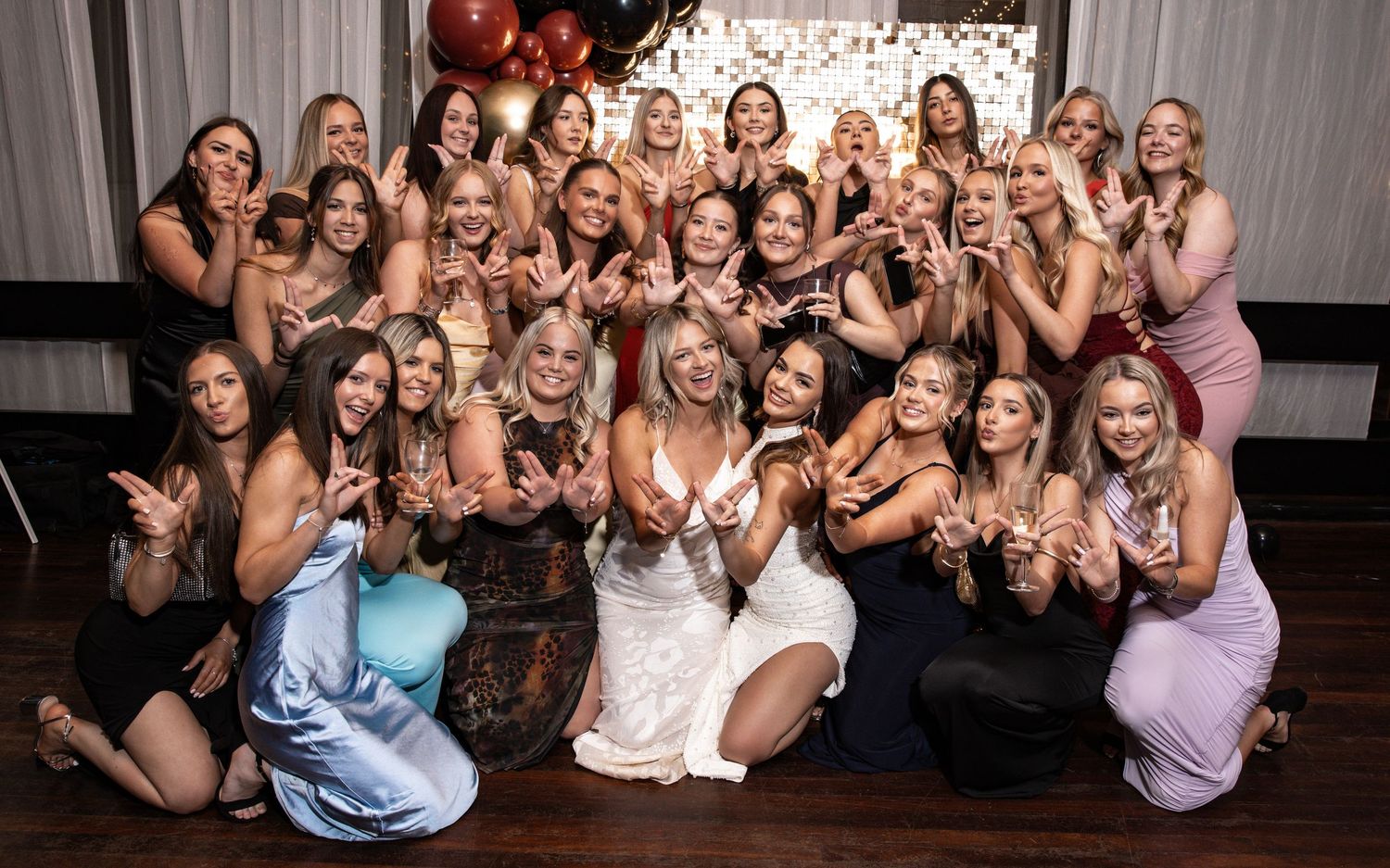 Large group photo at an awards night with attendees in formal attire posing together.