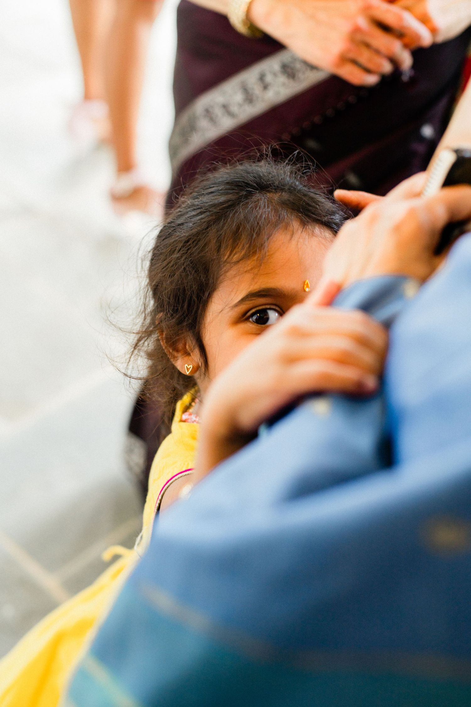 a child shyly looking into the camera