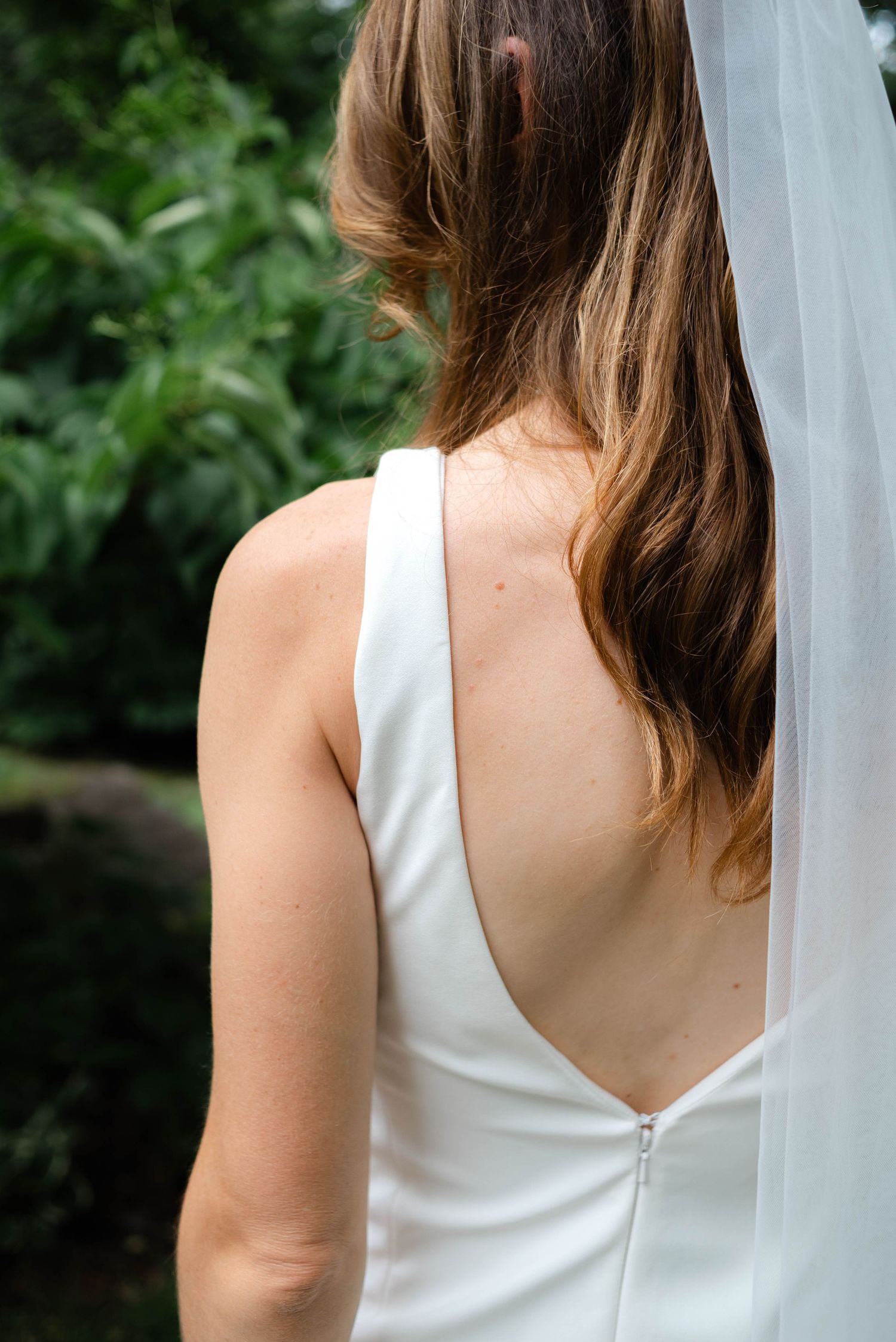 the back of the brides dress with veil