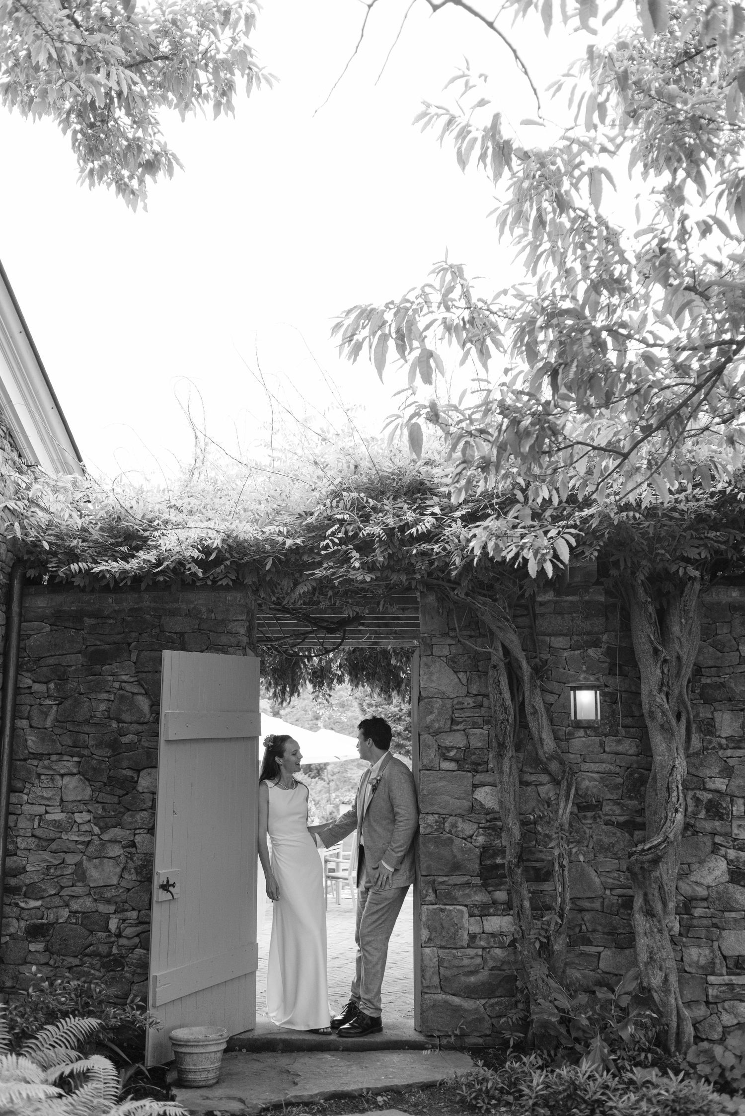 the bride and groom standing with each other in doorway