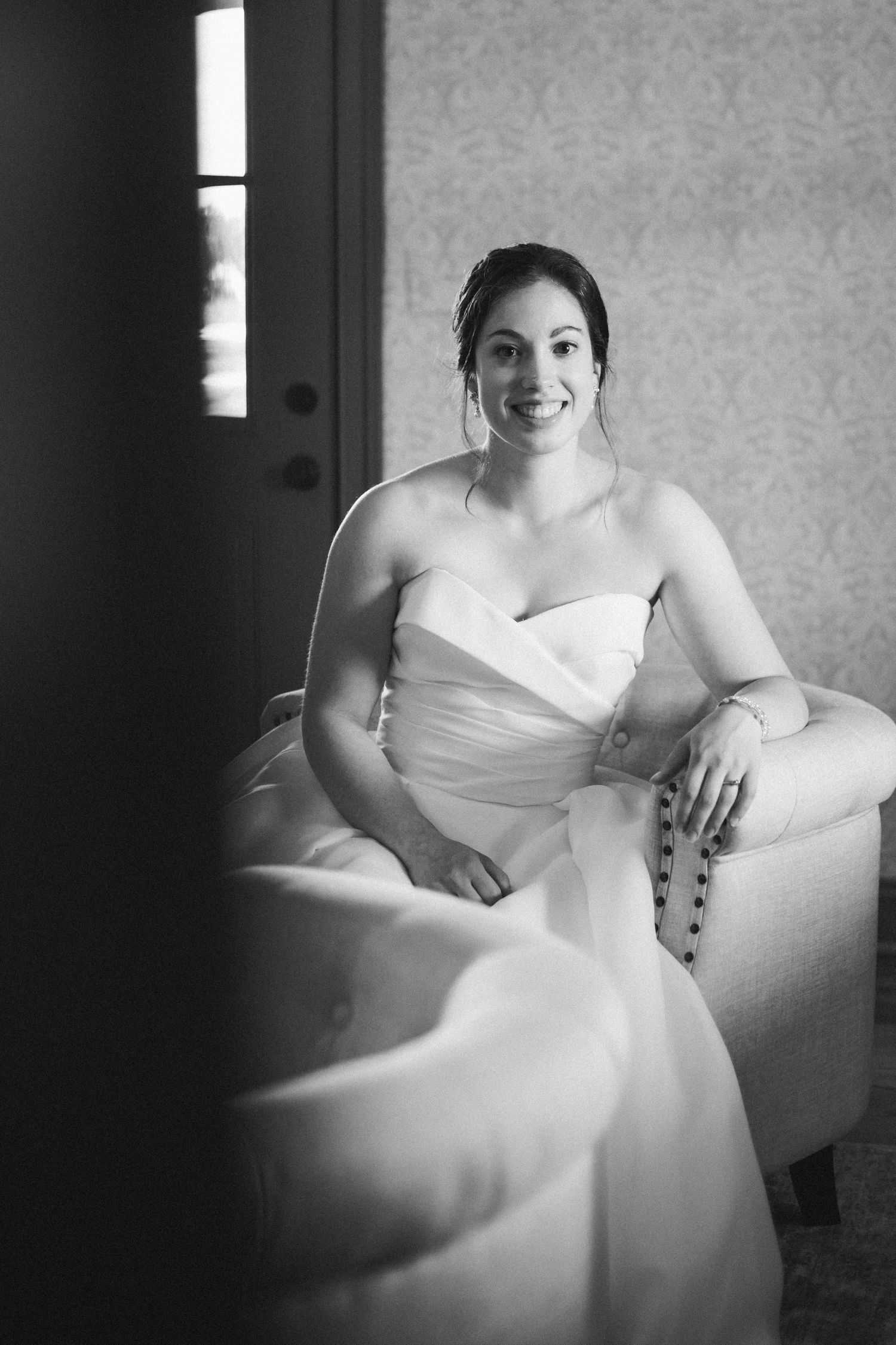 black and white image of bride smiling at the camera
