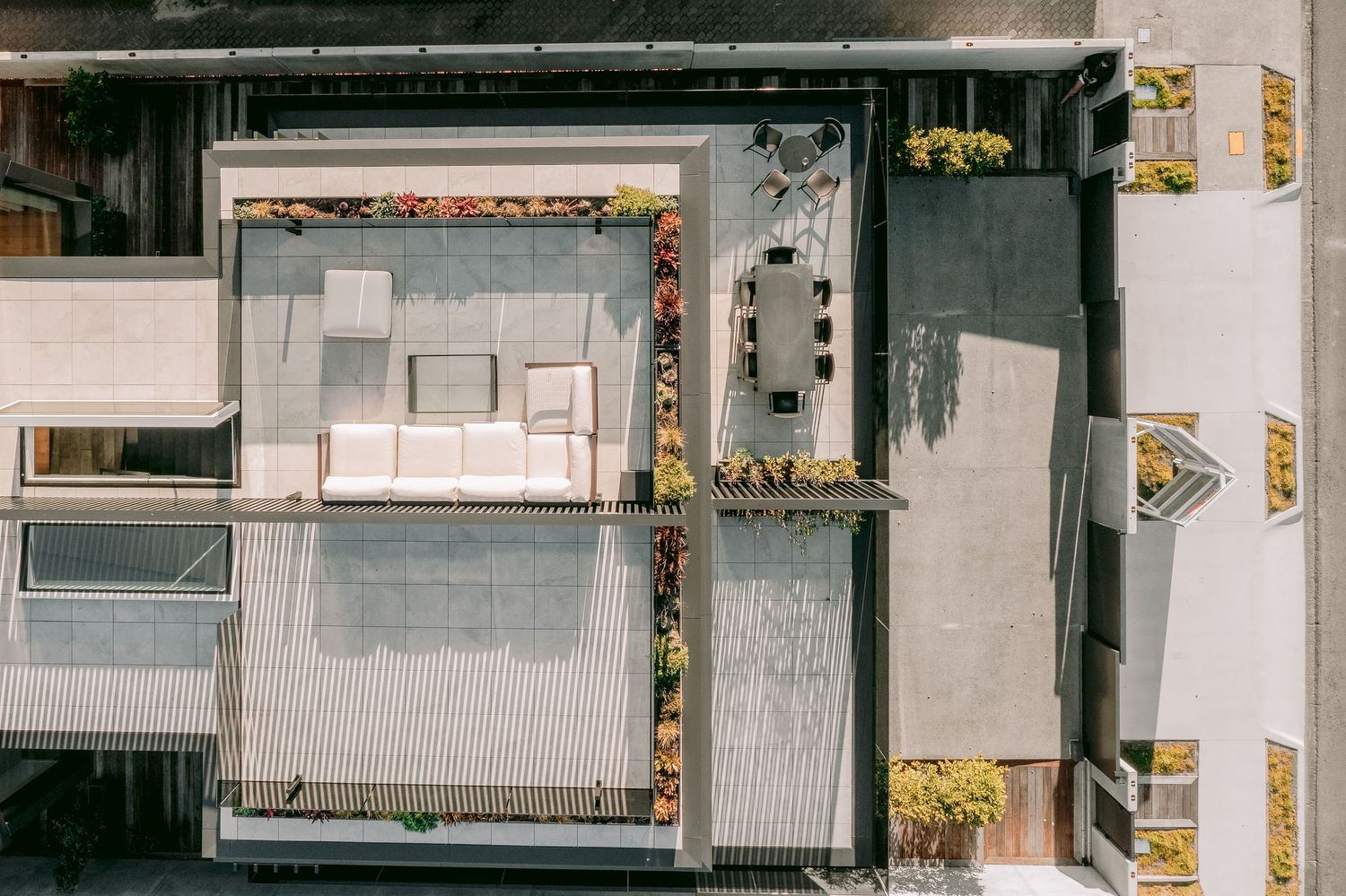 Aerial view of urban rooftops and building infrastructure on a cloudy day.