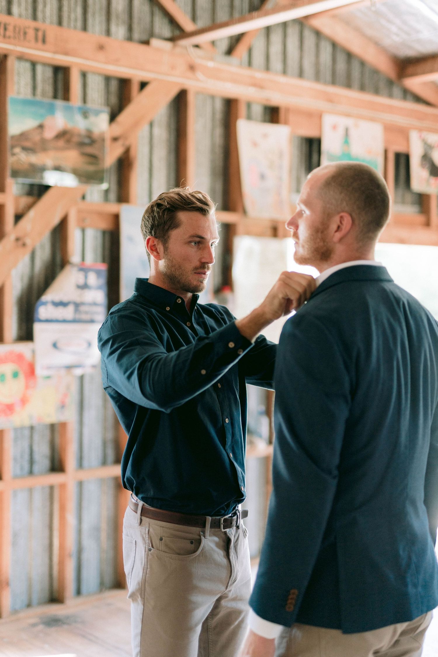 People interacting in a rustic wooden barn or workshop space.