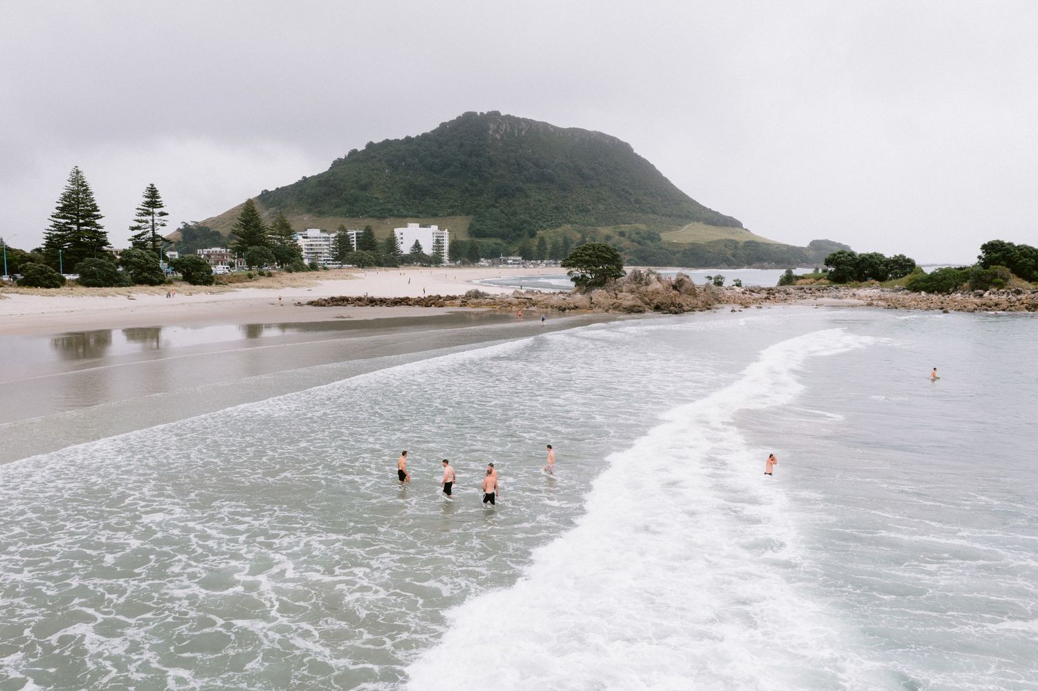 Scenic aerial panoramic view of Mount Maunganui beach and coastline in New Zealand during high tide.