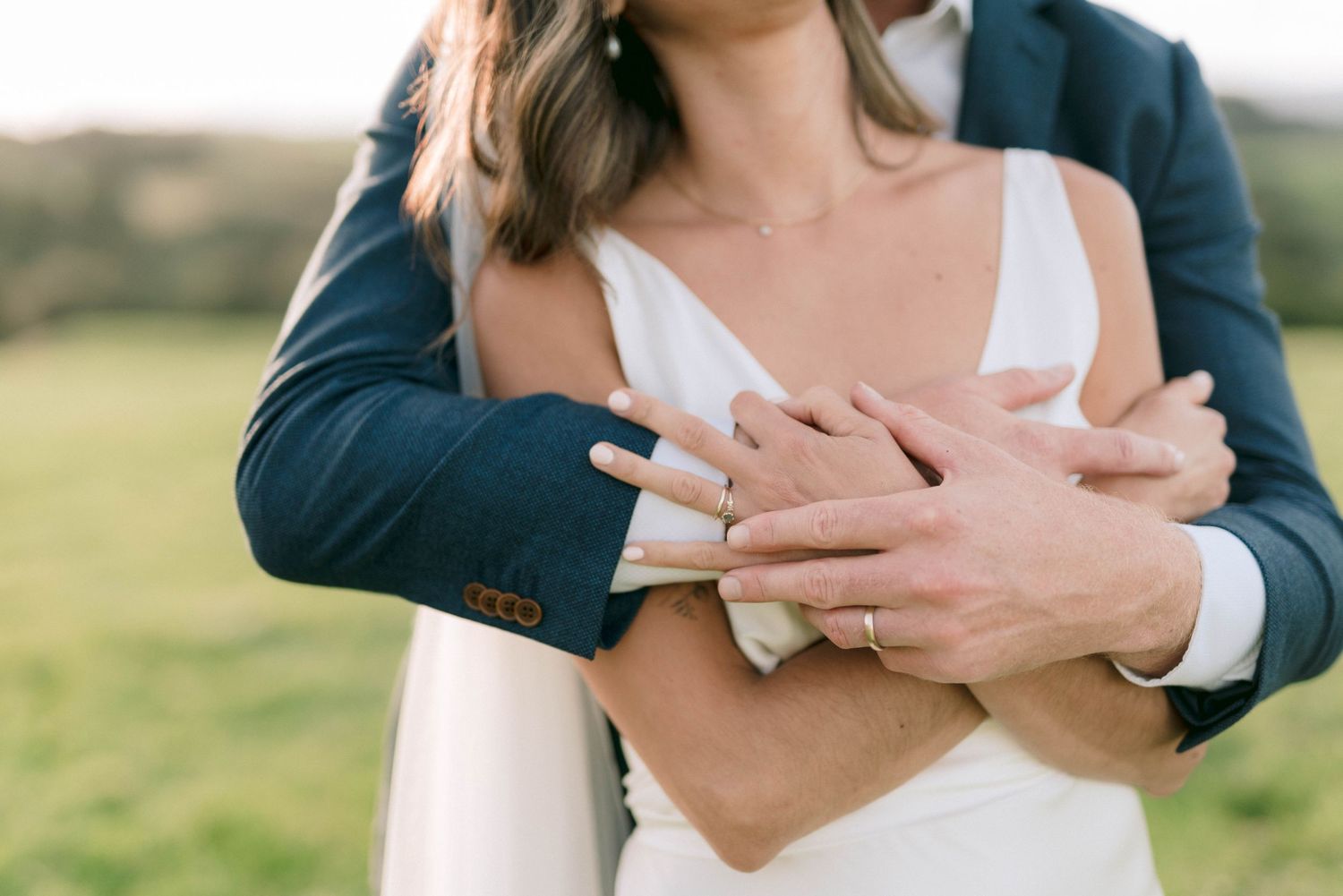 Close-up of couple's hands joined together during wedding celebration.