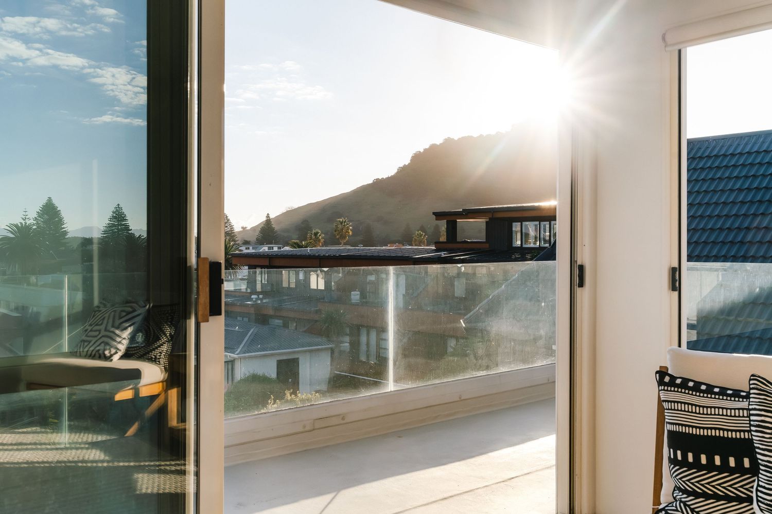 Sun-filled indoor seating area with large windows offering panoramic views of the surroundings.