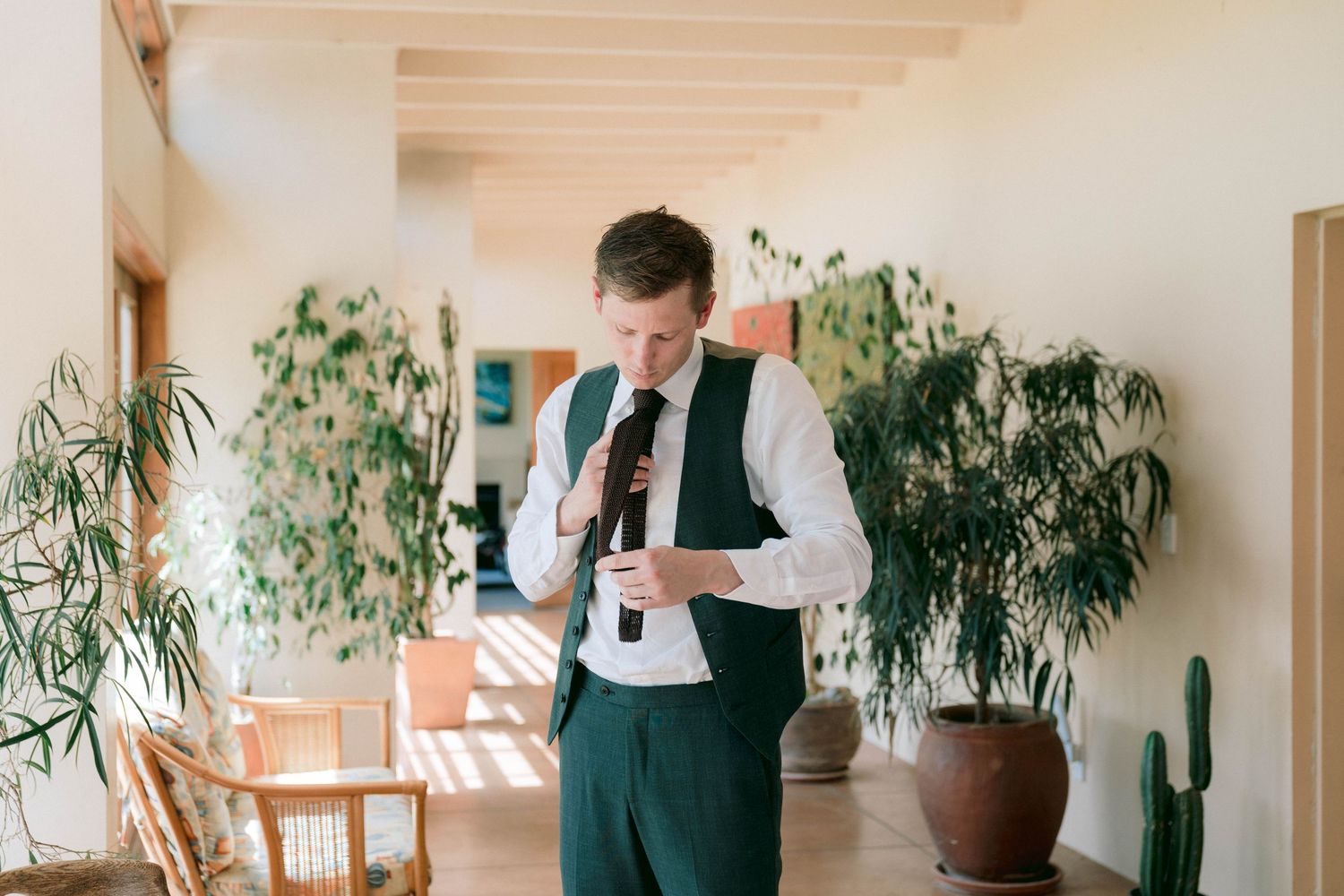 Elegant indoor venue with natural lighting and decorative plants along the walls.