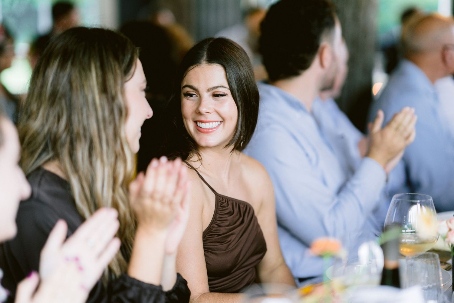 Wedding guests laughing and enjoying themselves during the reception celebration.