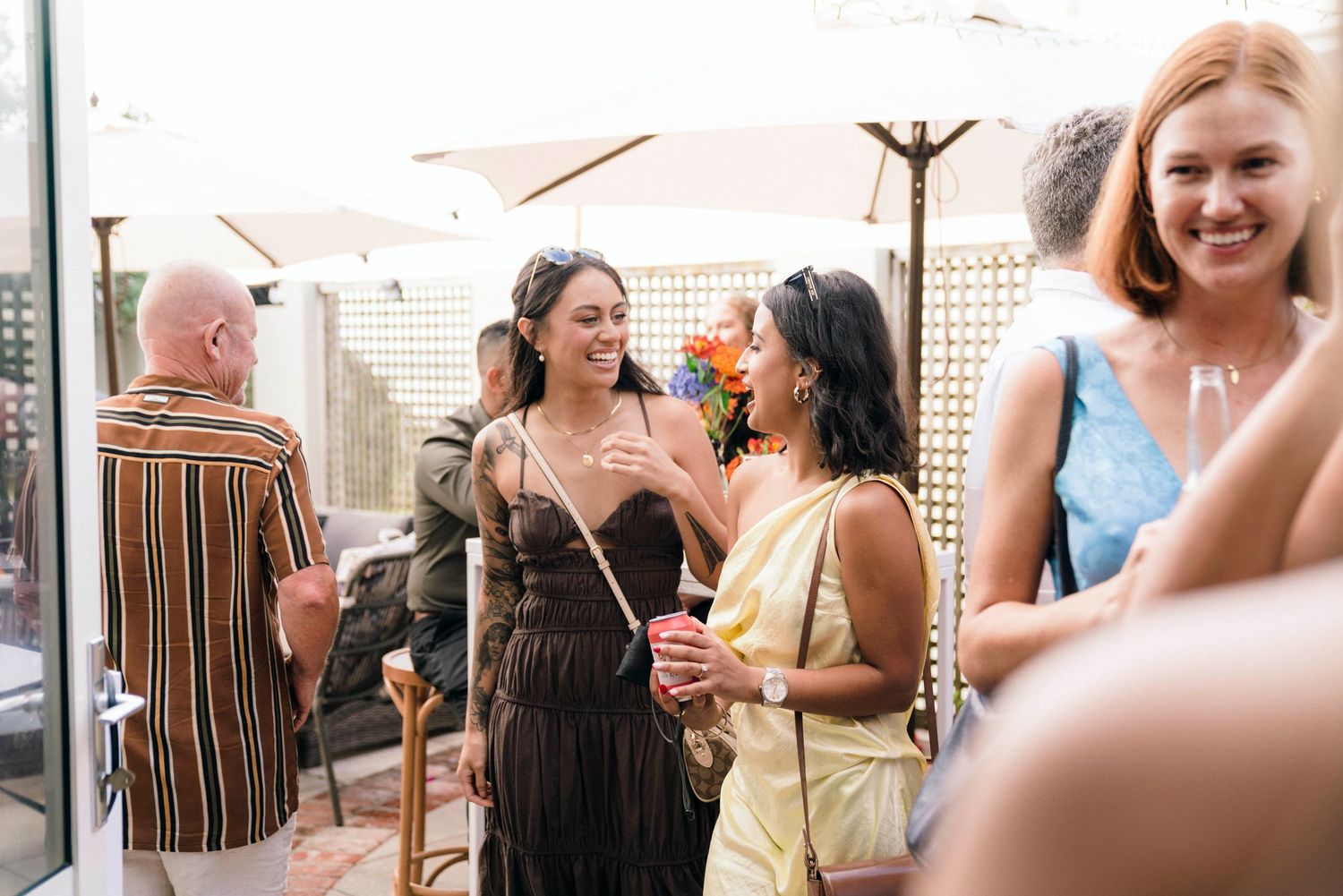 Group of friends chatting and mingling at an outdoor social gathering.