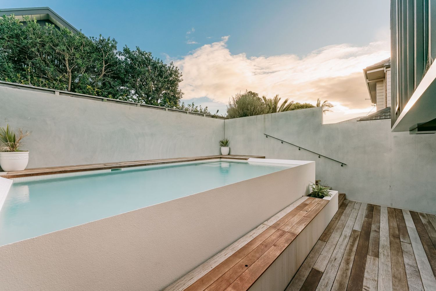 Contemporary deck space with white walls and wooden flooring extending outdoors.