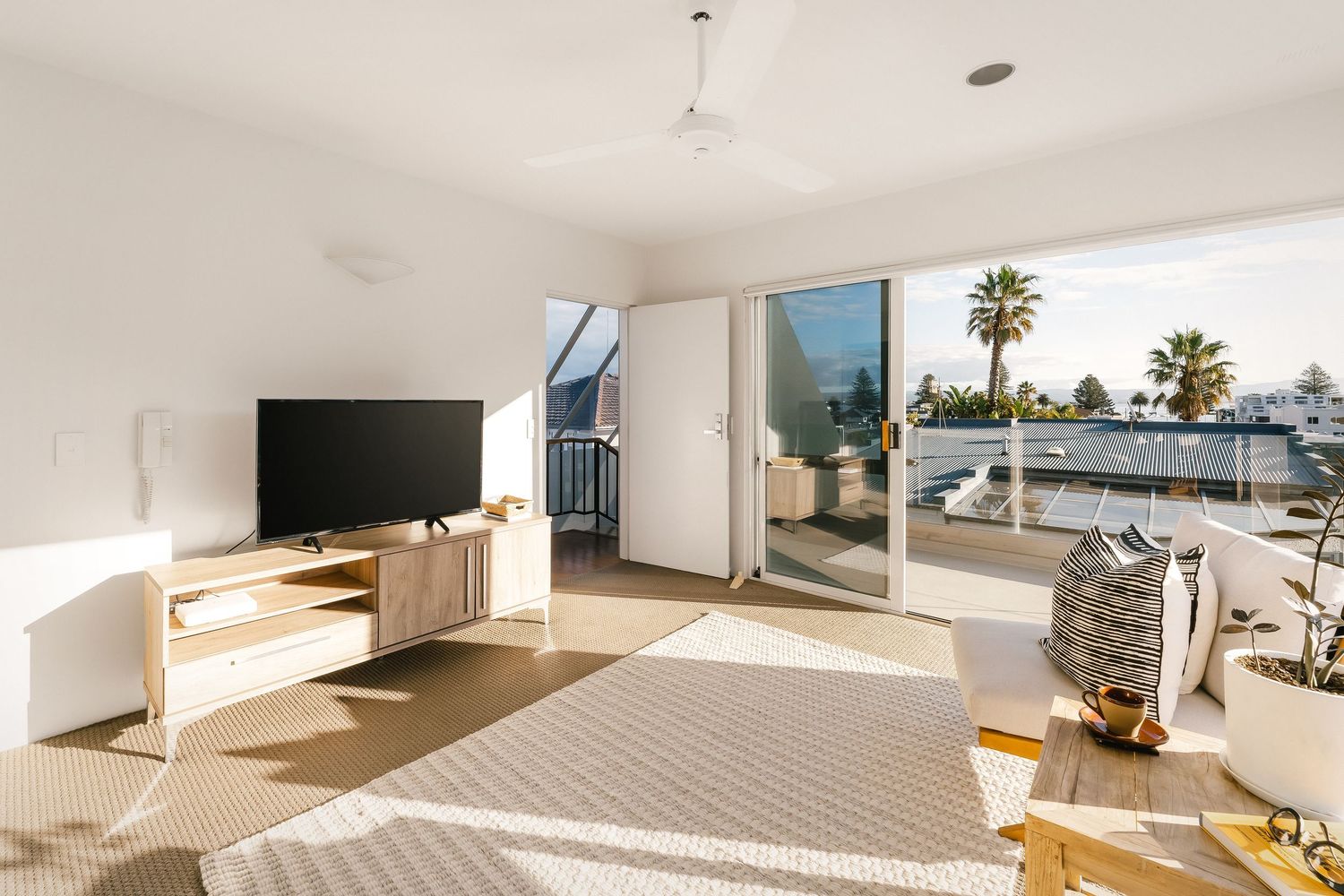 Spacious living area with floor-to-ceiling windows offers stunning outdoor views and modern amenities.