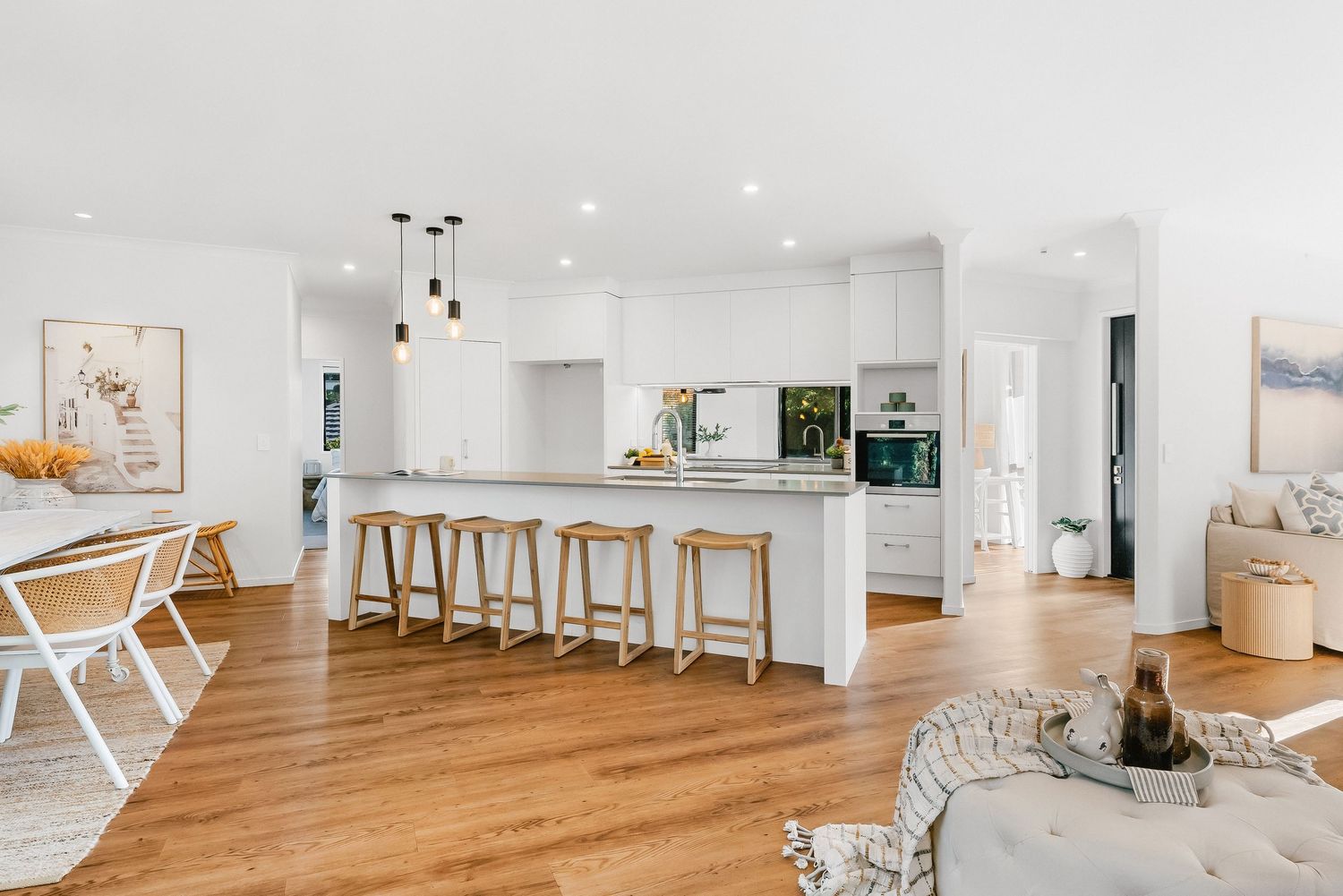 A bright, minimalist residential space with hardwood floors and white walls showcasing a clean, contemporary design style.