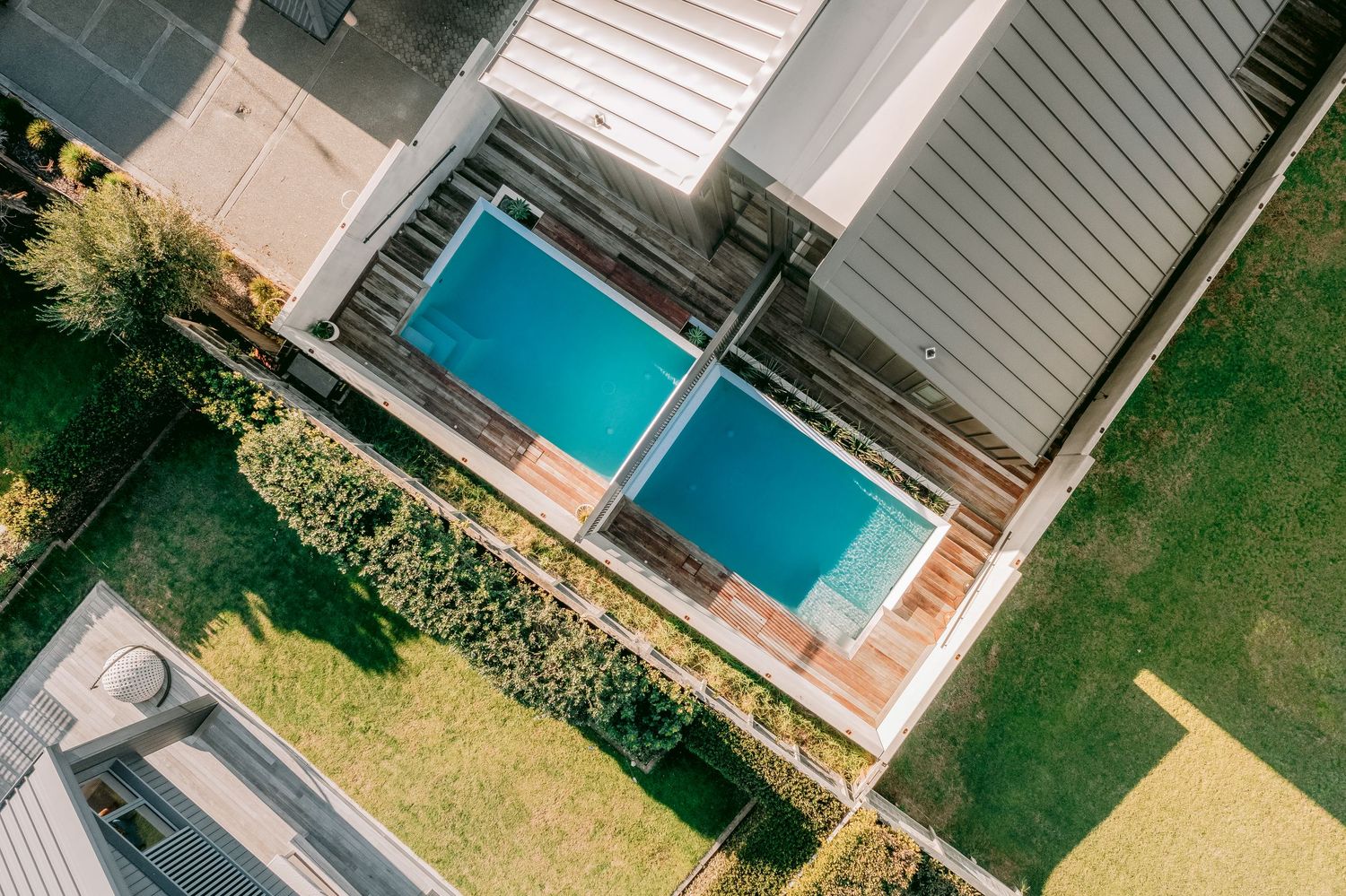 Aerial view of modern house with swimming pool and landscaped backyard.
