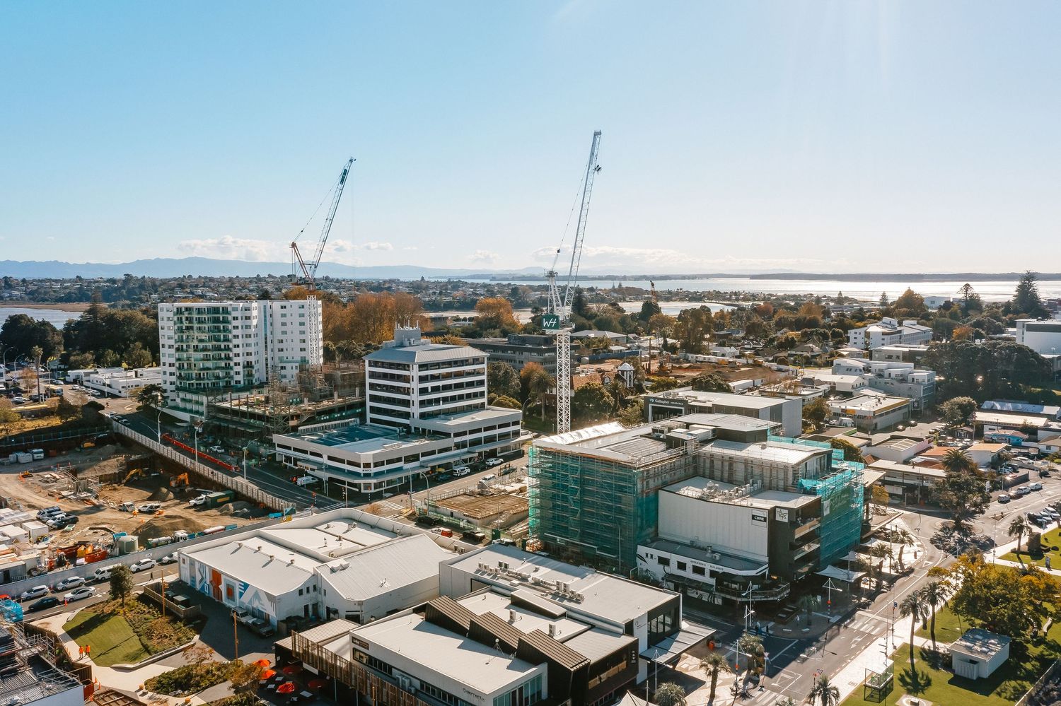 Aerial panoramic view of modern commercial development and construction sites in an urban business district.