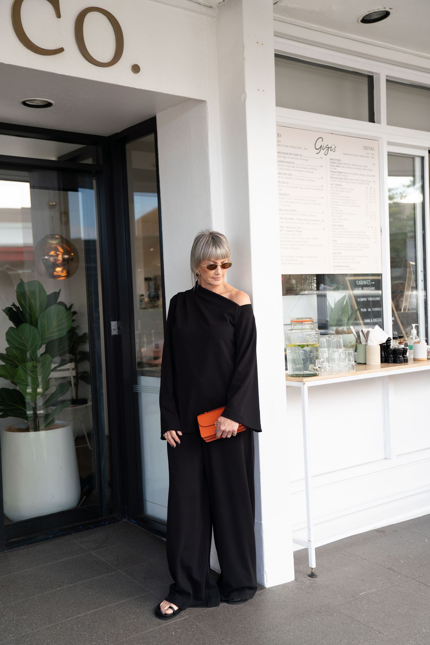 Multiple views of a modern white storefront exterior with glass windows and potted plants creating a minimal retail atmosphere.