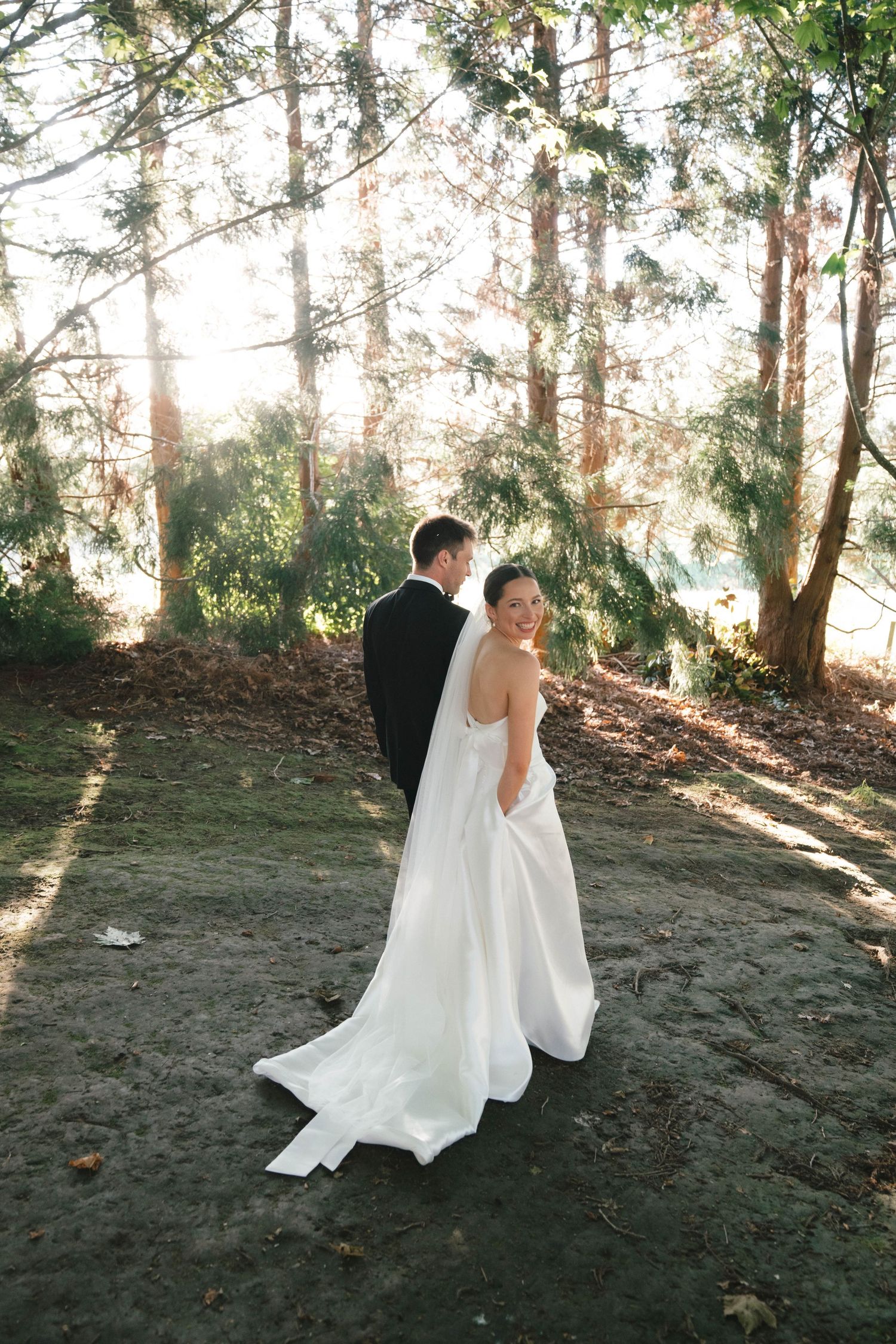 A wedding couple dances together in a sunlit wooded area, their movements captured in a series of artistic photographs.