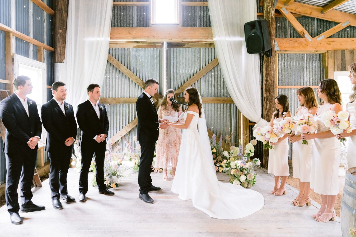 Wedding ceremony sequence showing guests and wedding party in a rustic barn setting.