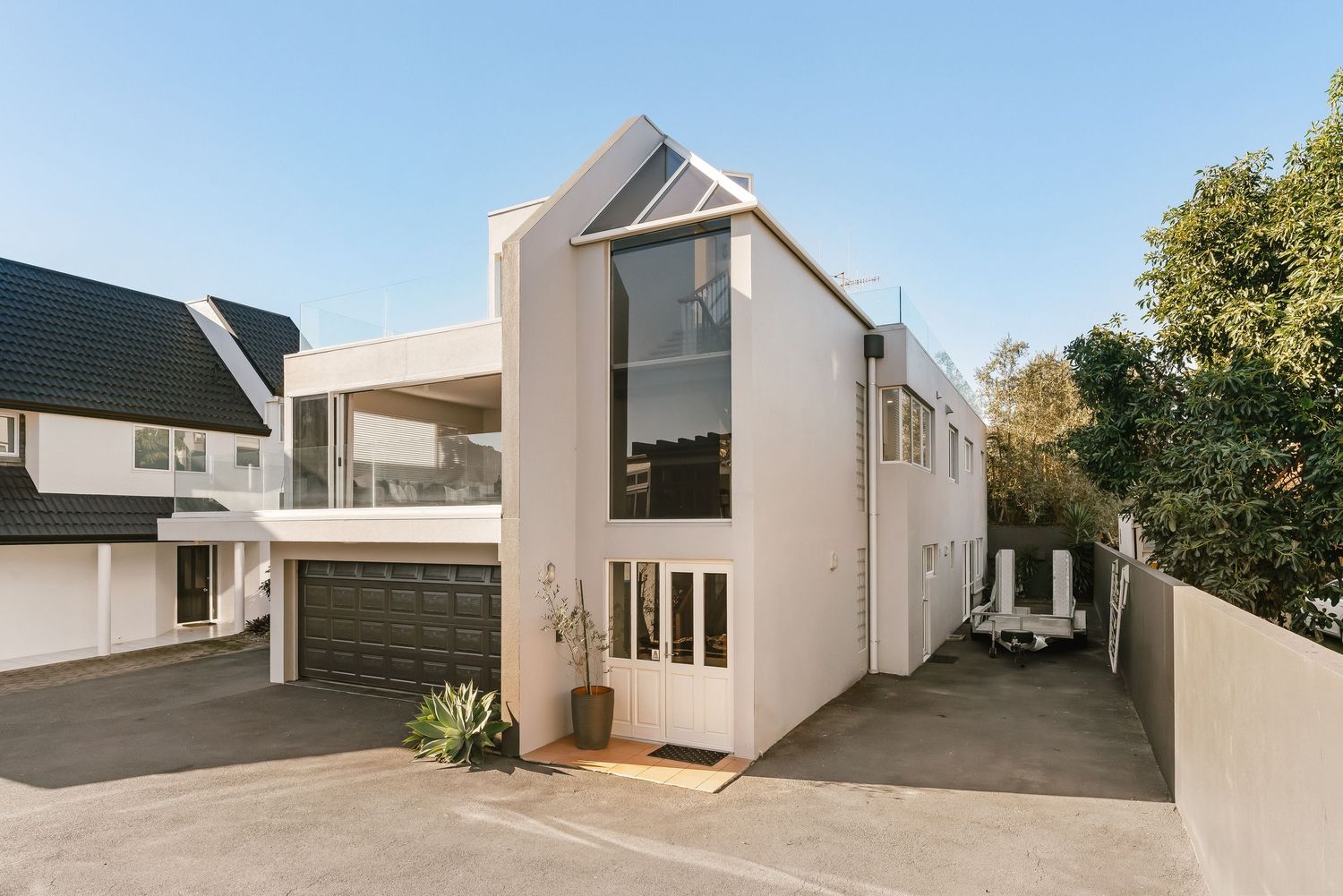 Contemporary white townhouse complex with minimalist design and clean exterior finishes.